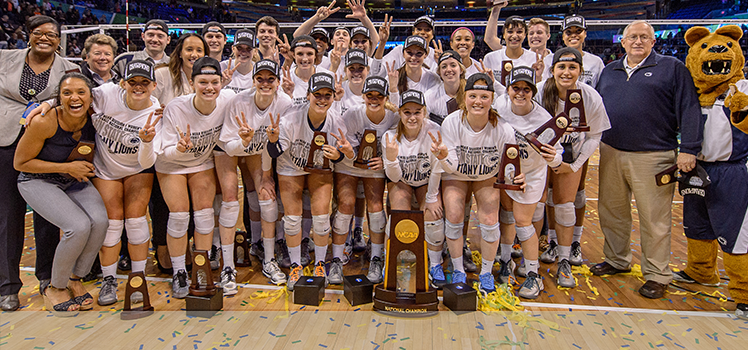 The Penn State women's volleyball team, coaches and the Nittany Lion mascot celebrate after the win.