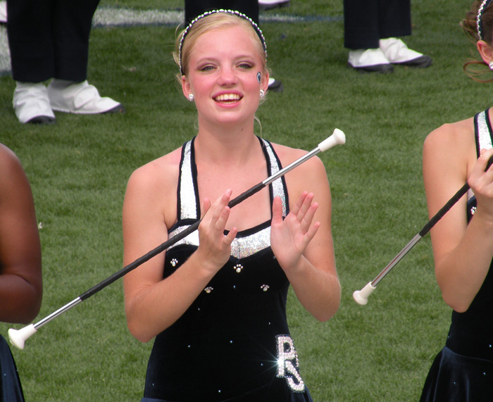 Jennifer Chelko, a Blue Band majorette, spinning a baton while in full dress.