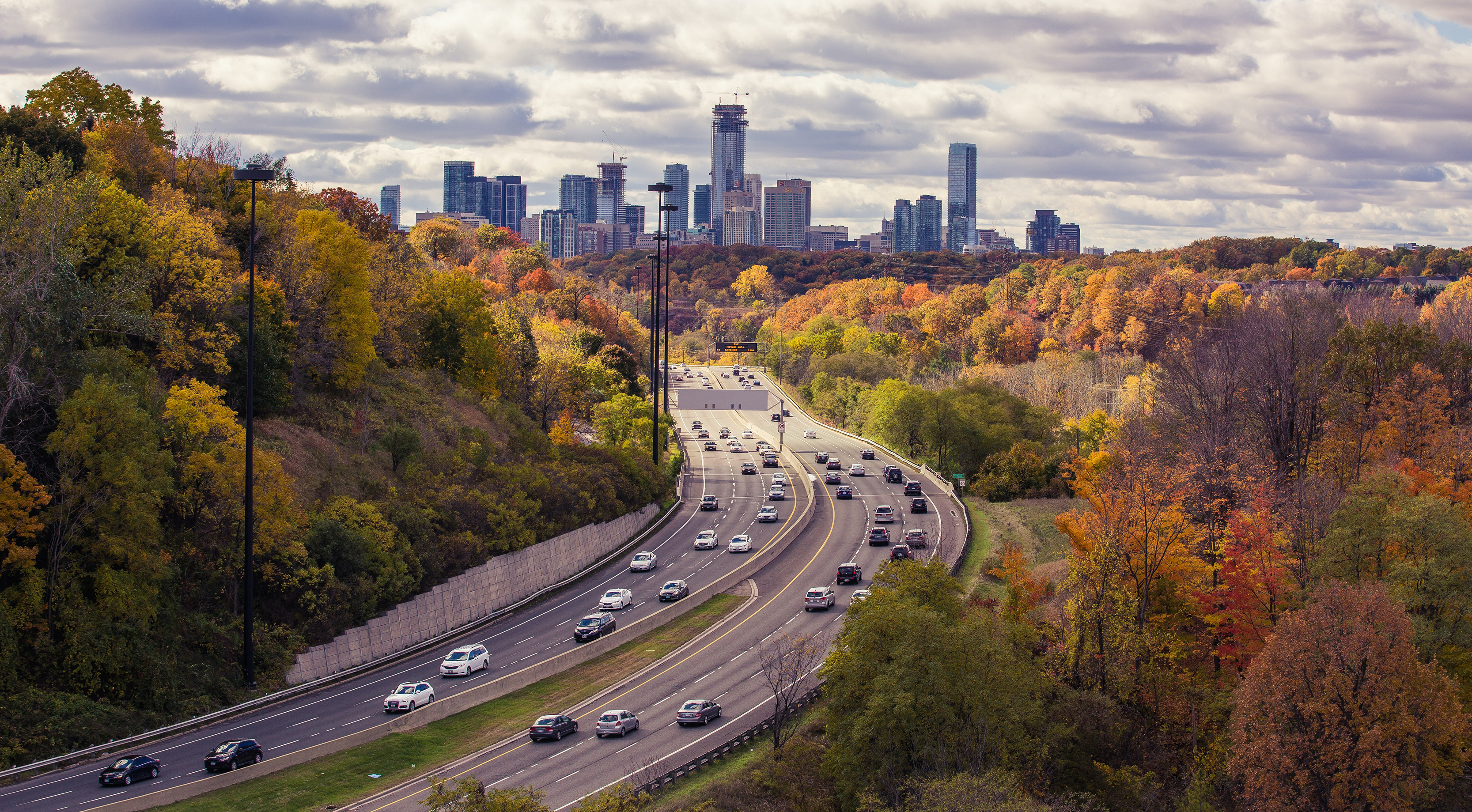 An overhead view of auto traffic driving into a city