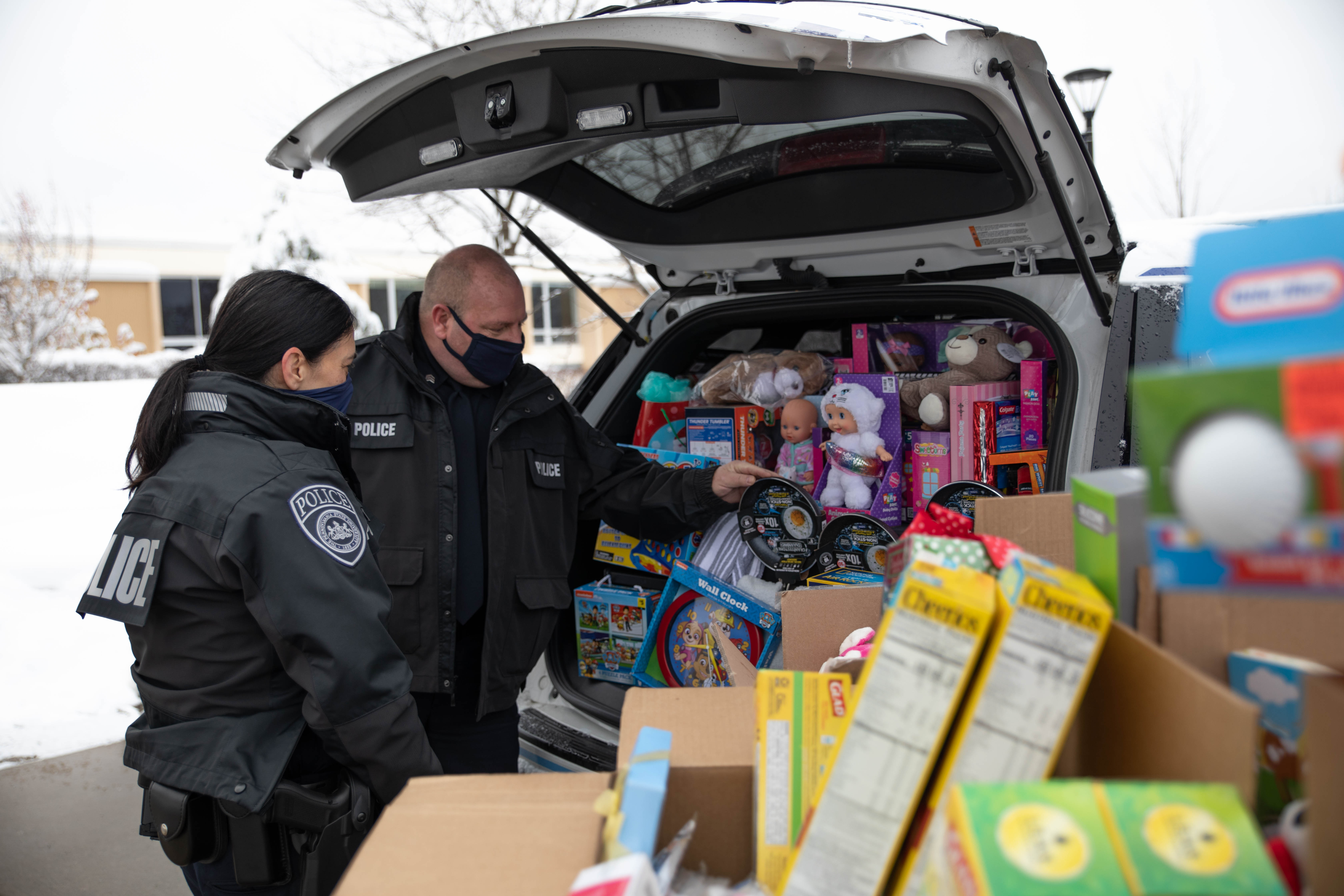 Police officers load cruiser with donated items