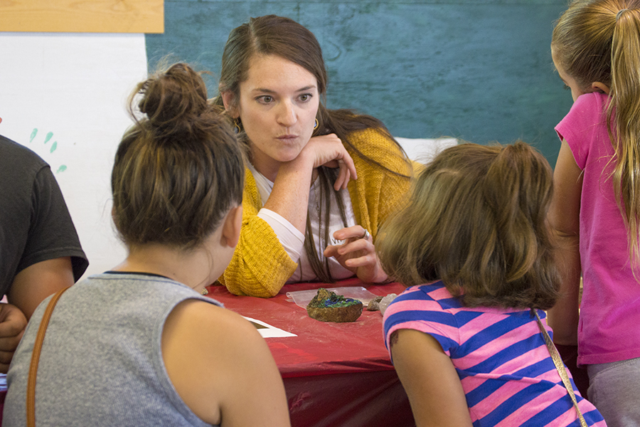 Virginia Marcon, a Ph.D. candidate in geosciences and co-president of the group WE ARE for Science, talks to children about the study of the Earth during the group's Ask a Scientist event recently at the Grange Fair.