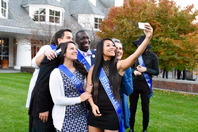 Student Homecoming Court students pose together for a selfie