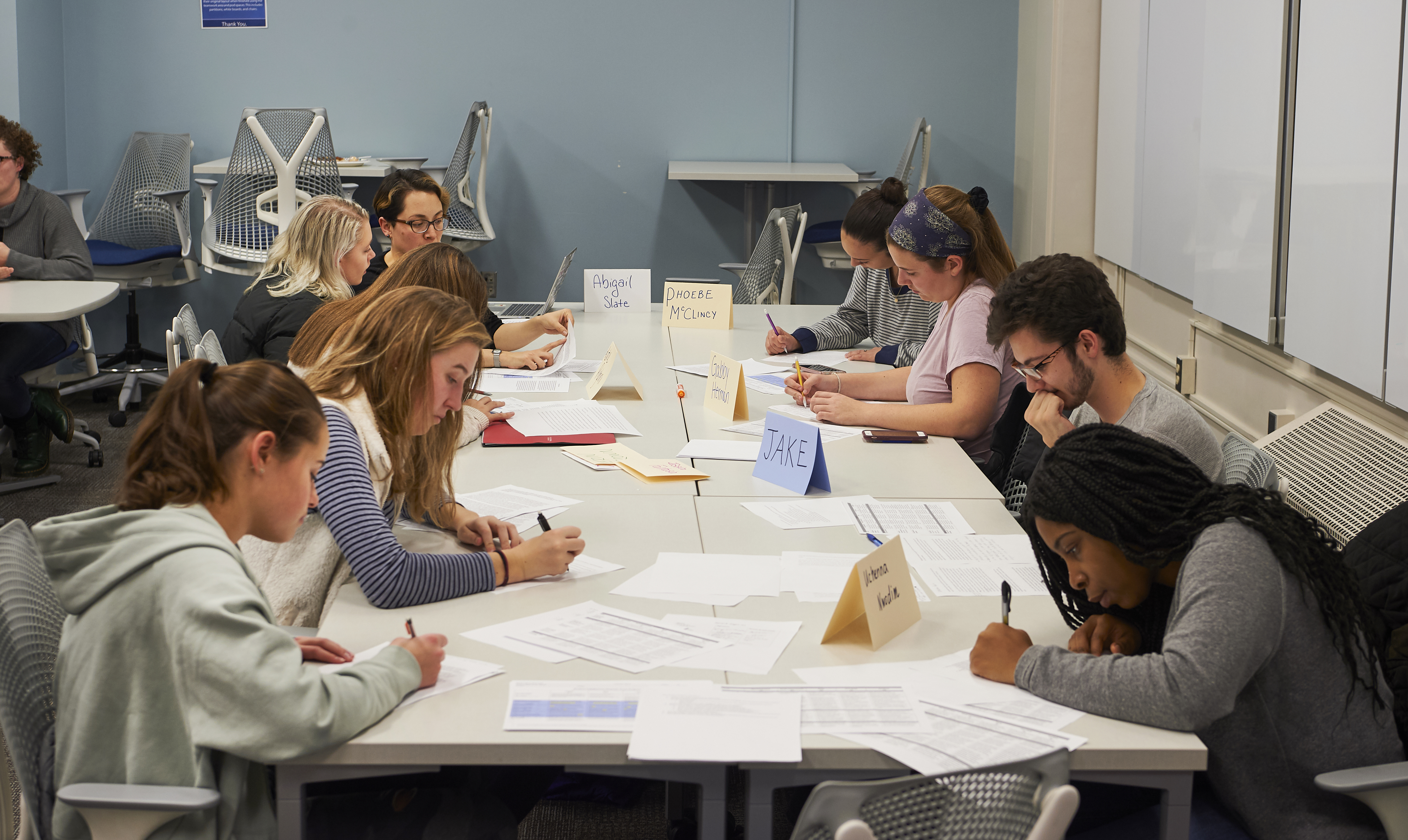 Students all working together on an assignment at large table