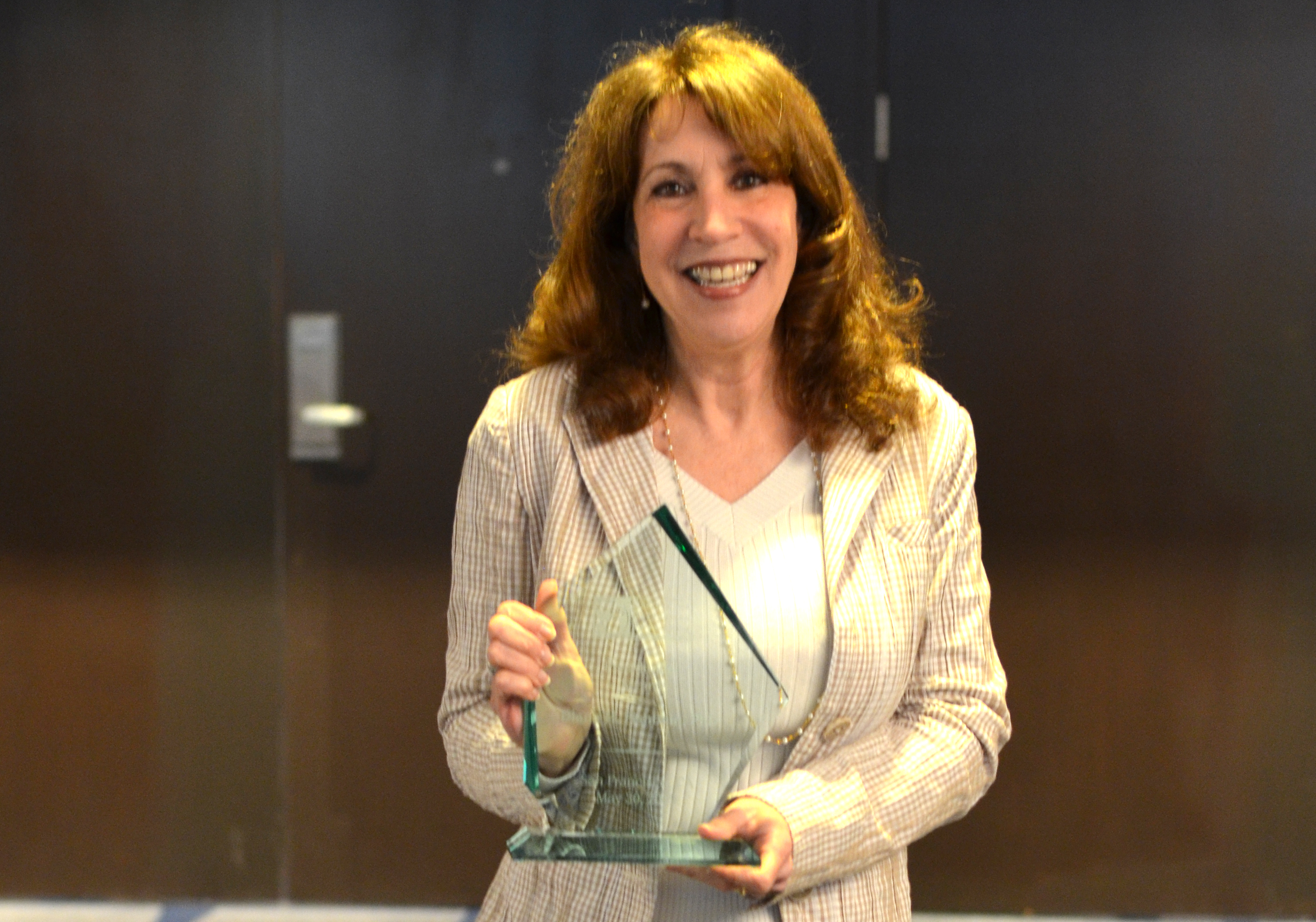 woman holding glass trophy