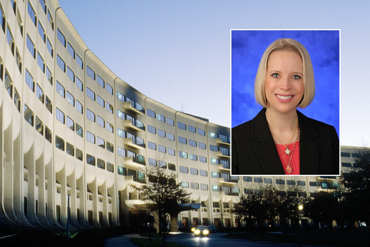 A head and shoulders professional photo of Dr. Jennifer Kraschnewski against a picture of Penn State College of Medicine. 