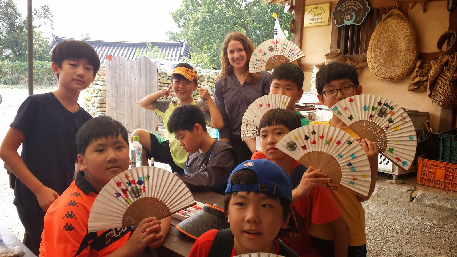 Penn State graduate Emily Sabo stands with students on a from one of the fourth-grade classes she teaches in South Korea.