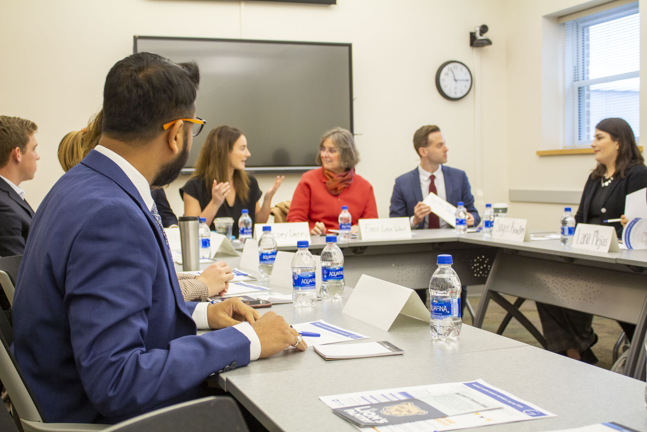 First Lady Wolf sits with students around a table