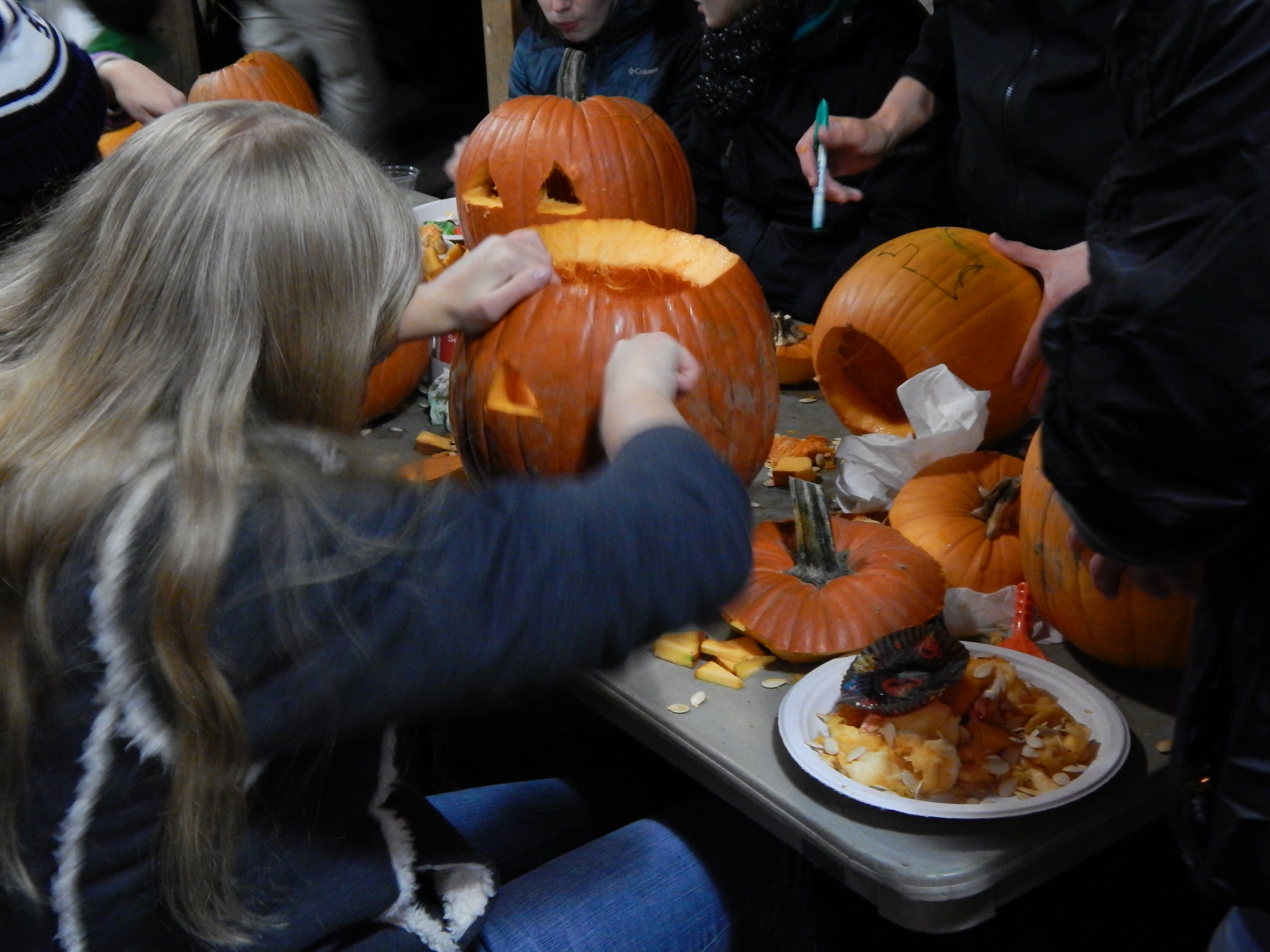 Volunteers carve jack-o-lanterns