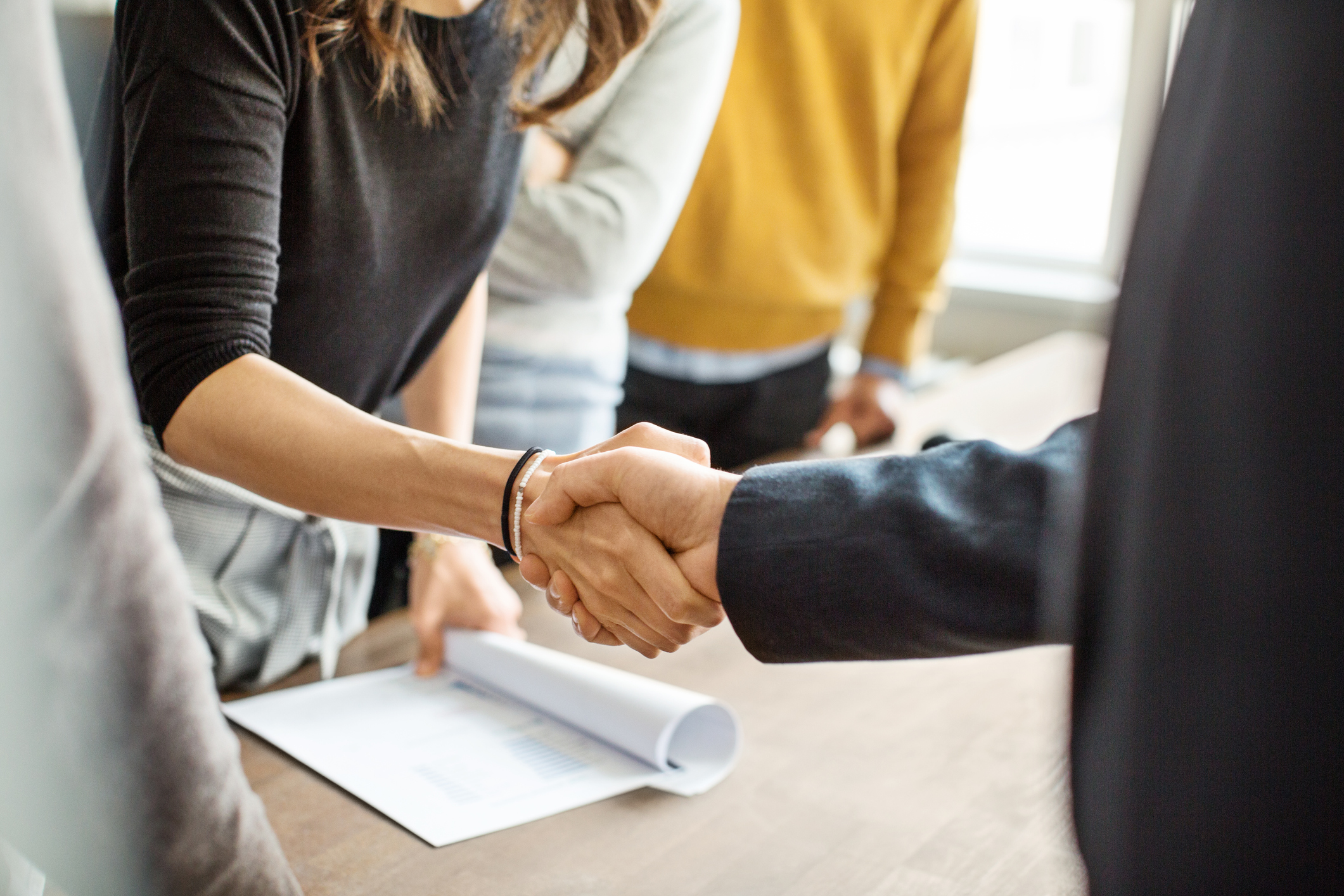 Close up of a woman CEO shaking hands with someone