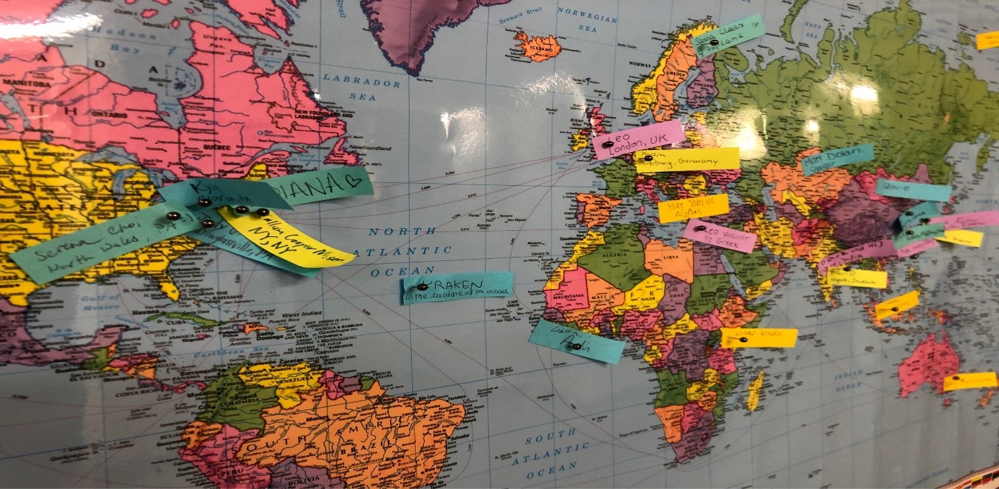 A photo of a world map with pins depicting the home countries of the students in the GEC