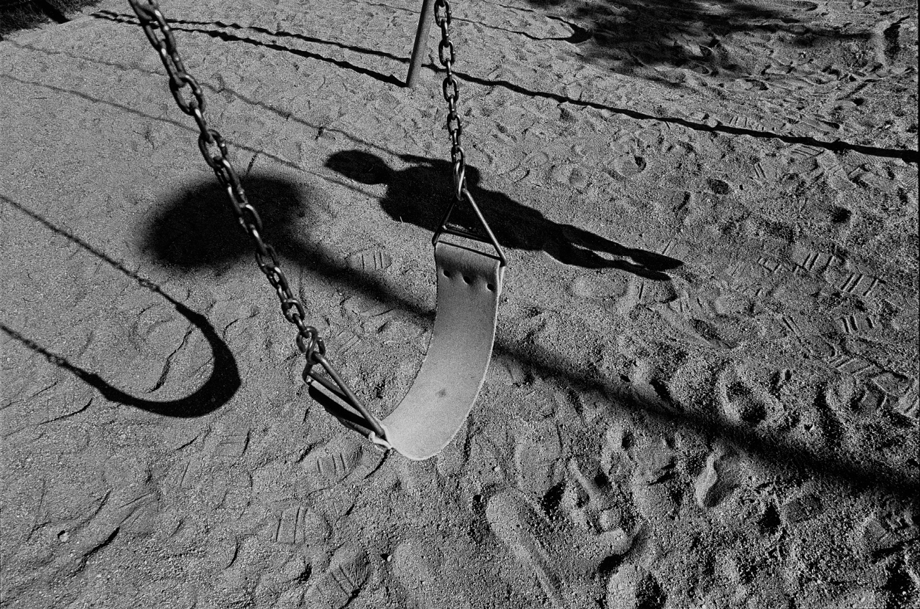 Empty swingset on a playground stock image