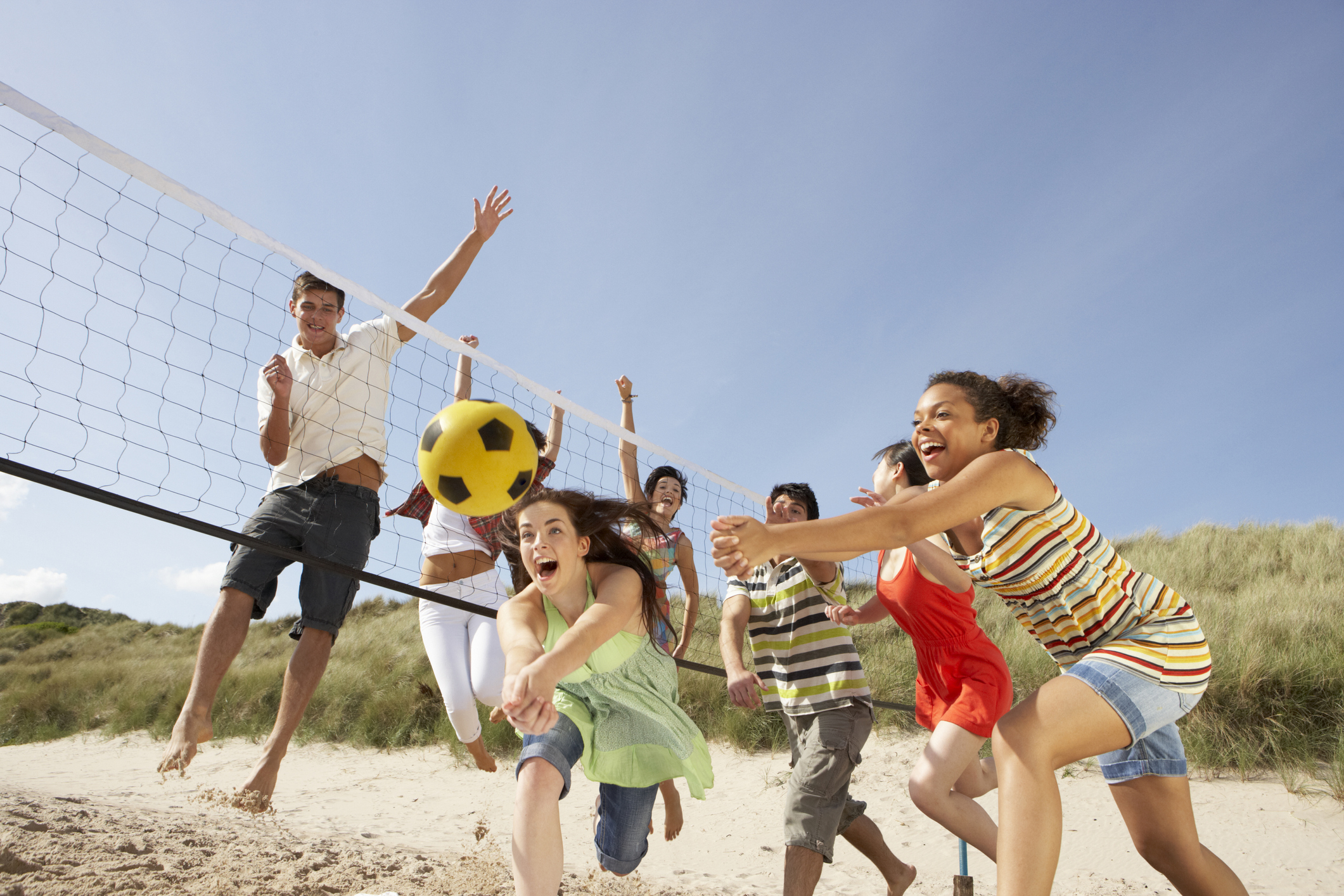 teens playing vollyball