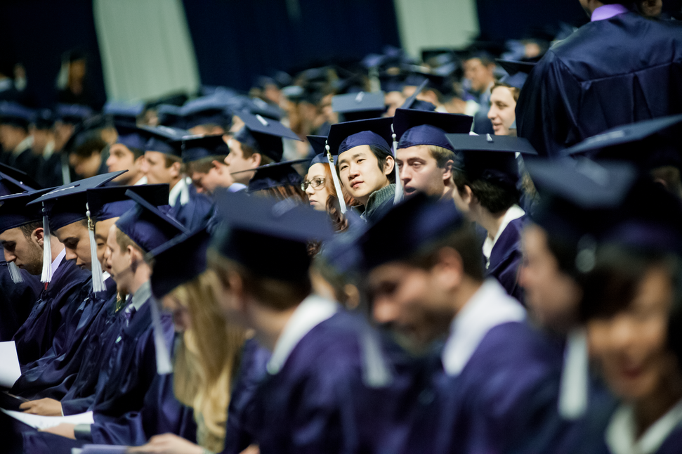 crowd of students in graduation caps and gowns