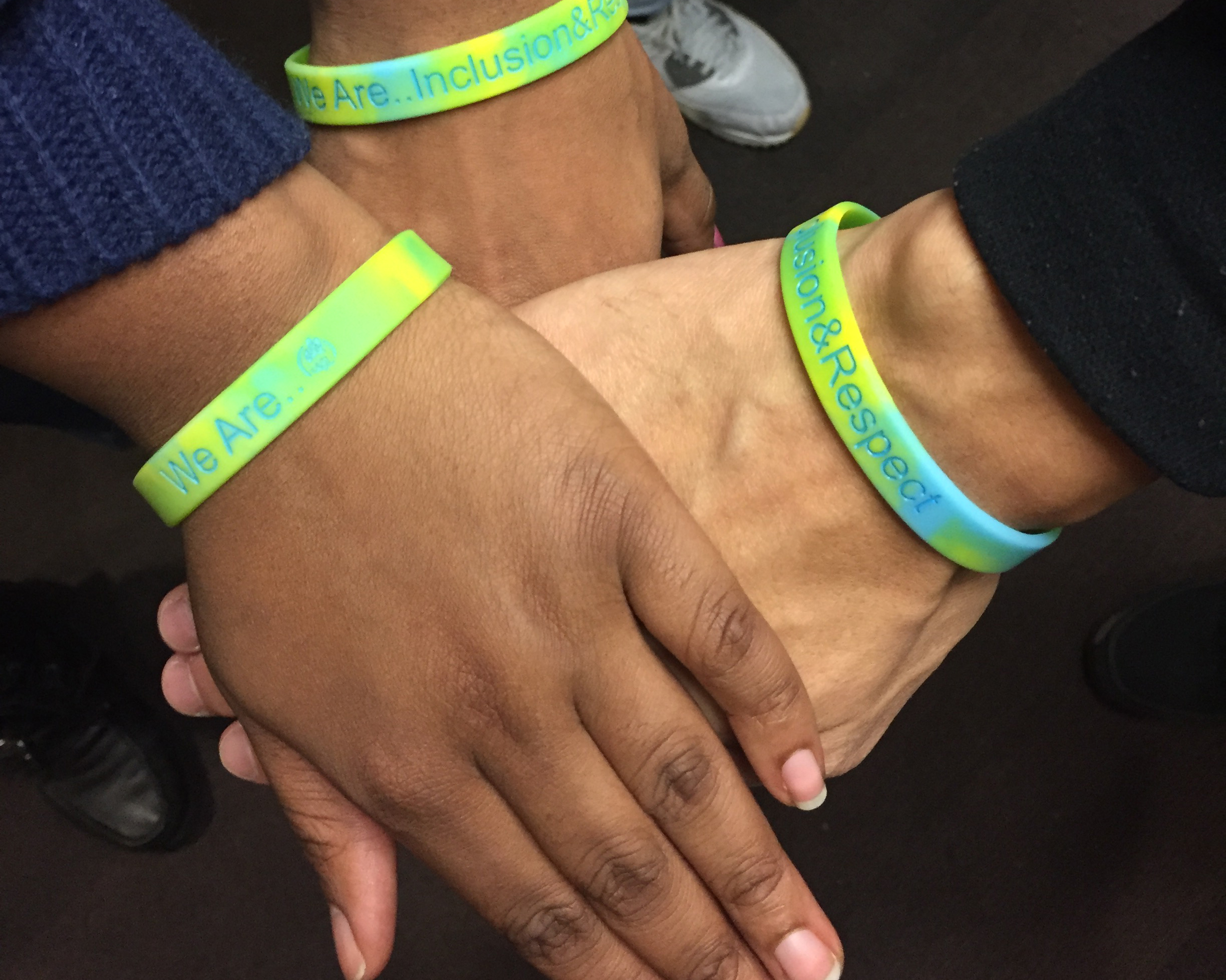 Students hands wearing diversity bracelets