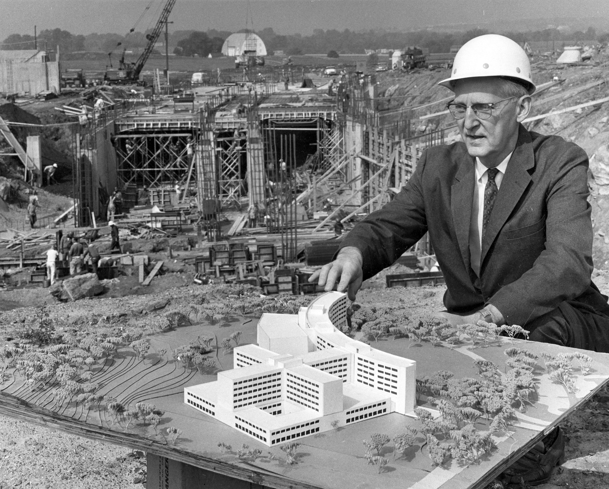 Dr. Harrell with model of Hershey and construction, 1966