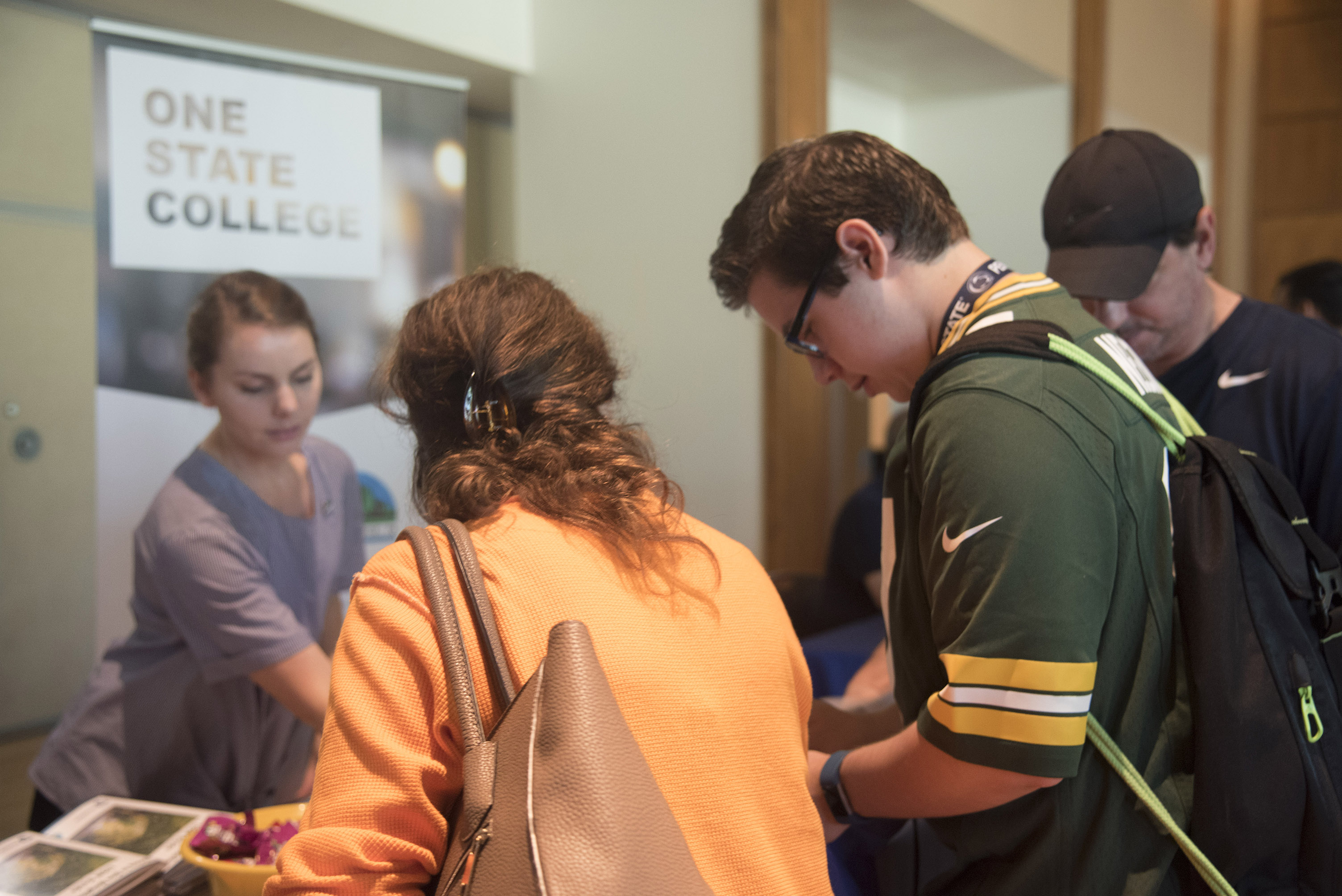 Student and parent talking to housing fair vendor