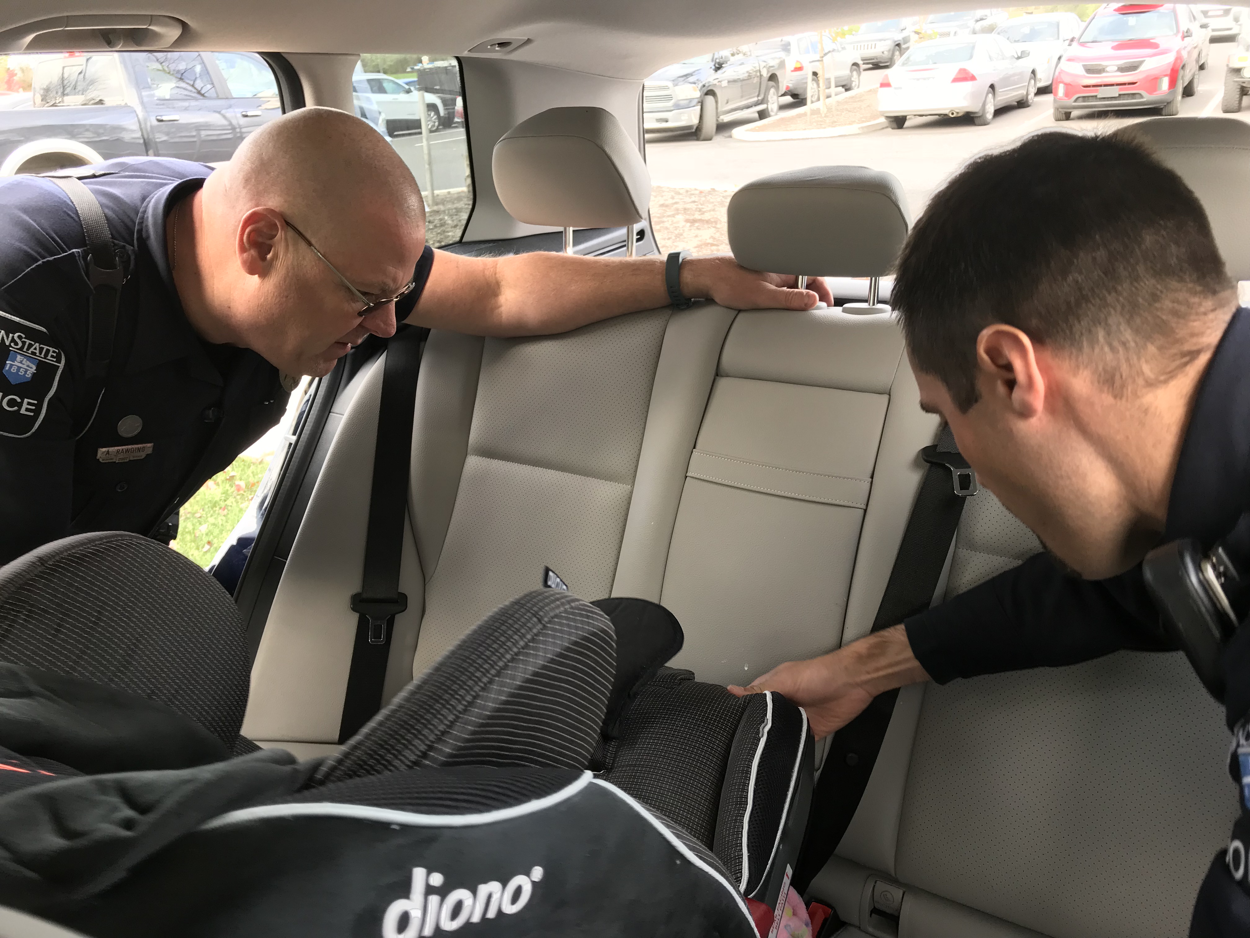 officers inspect child safety seat