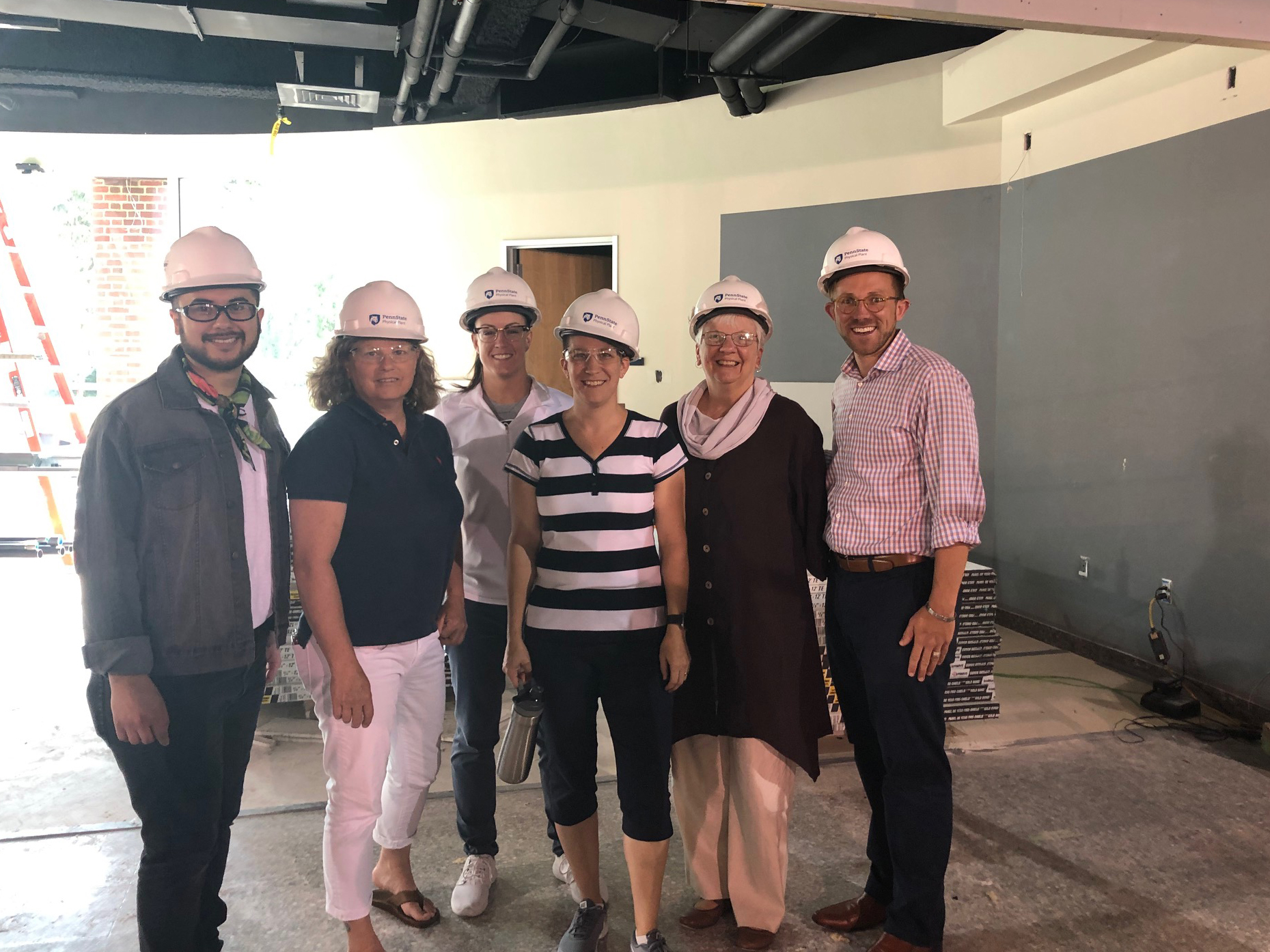 Staff wearing hardhats in construction space