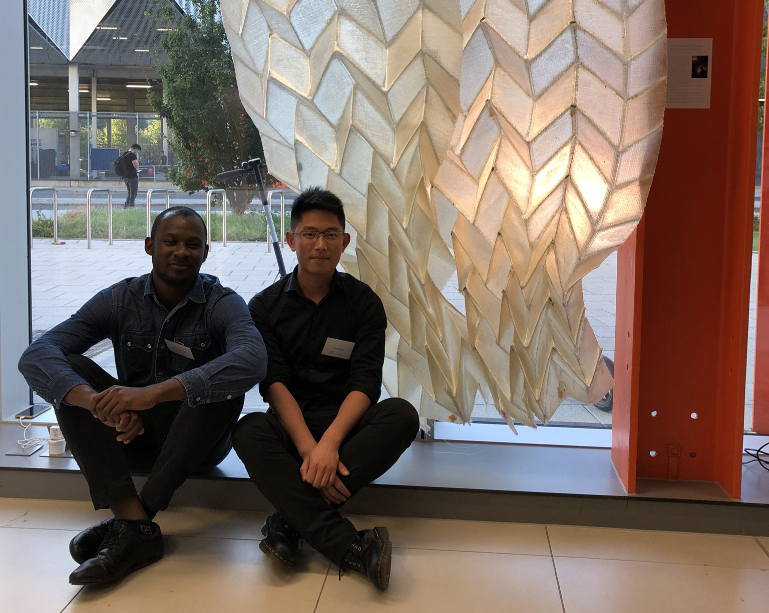 Landscape architecture alums Jimi Demi-Ajayi and Julian Huang in front of their “Phototropic Origami Structure” project at the Textile Intersections conference in London. 