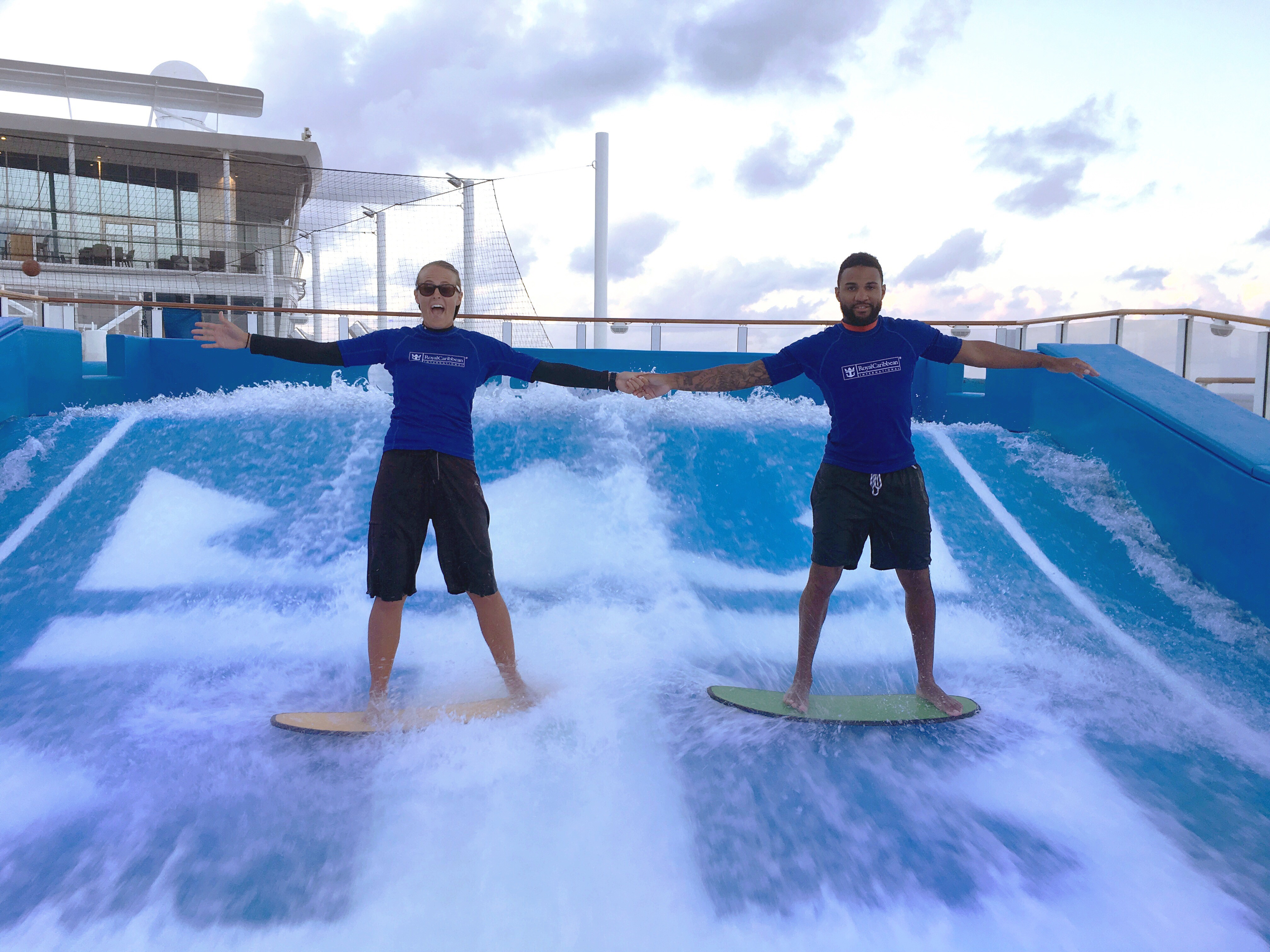 Tariq Tongue and Shannon Hutchinson on a surfboard simulator