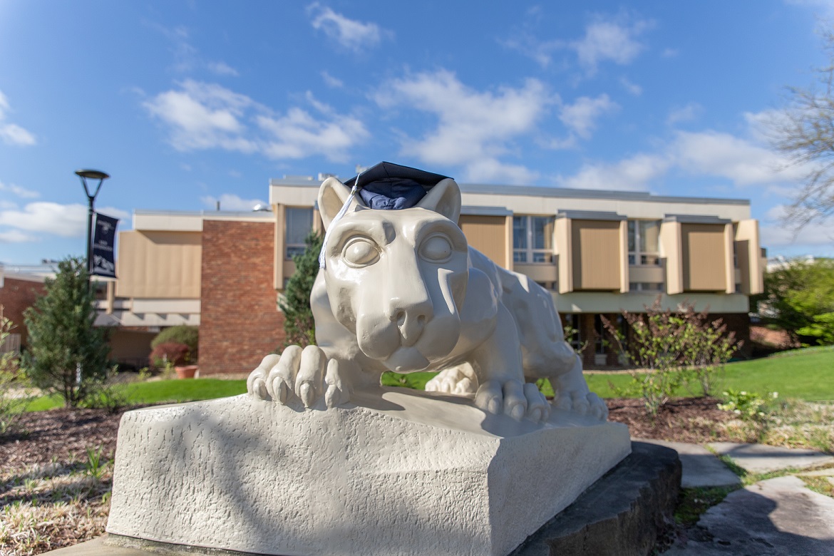 Lion shrine statue with graduation mortarboard