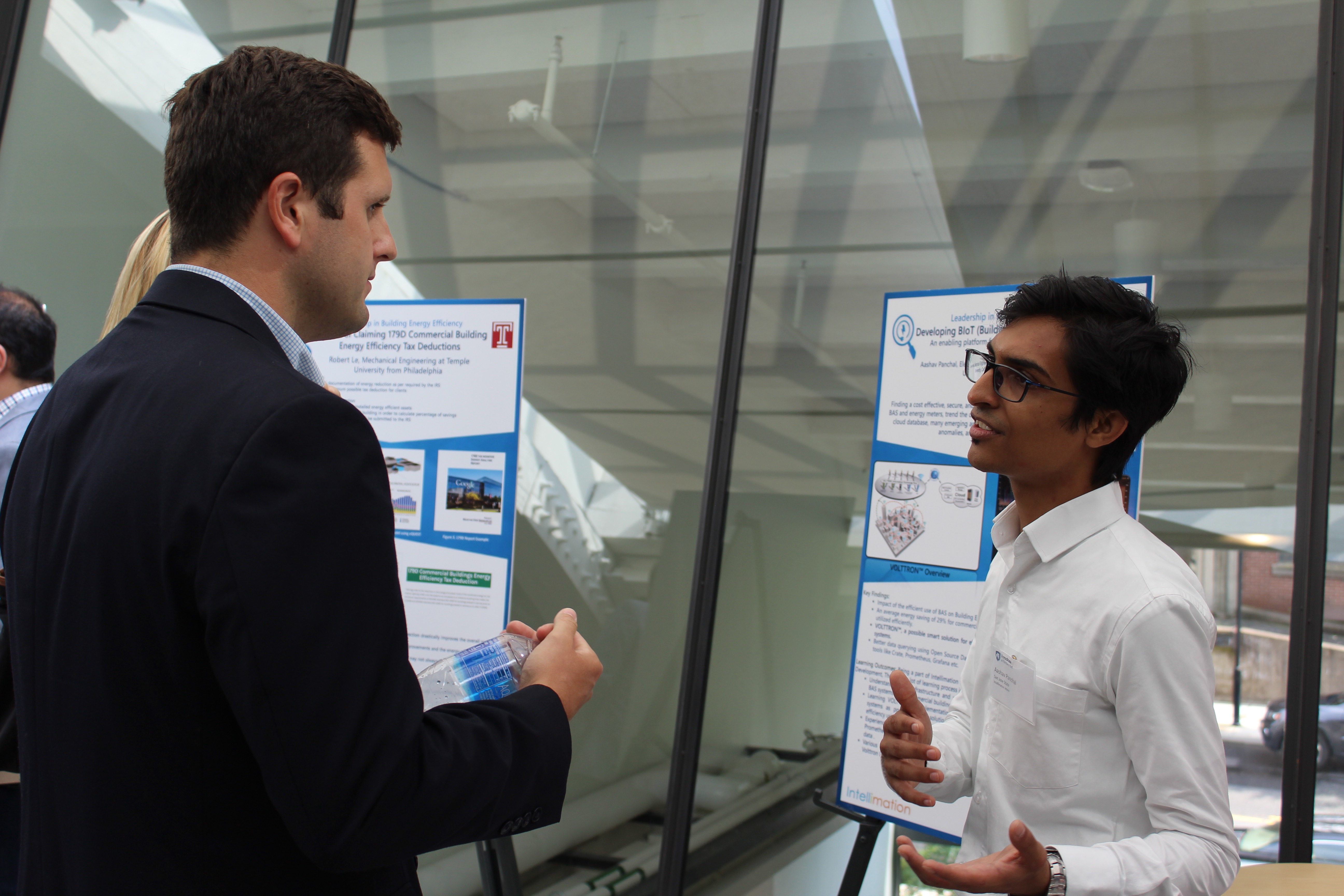 Student talking to professional representative at poster presentation