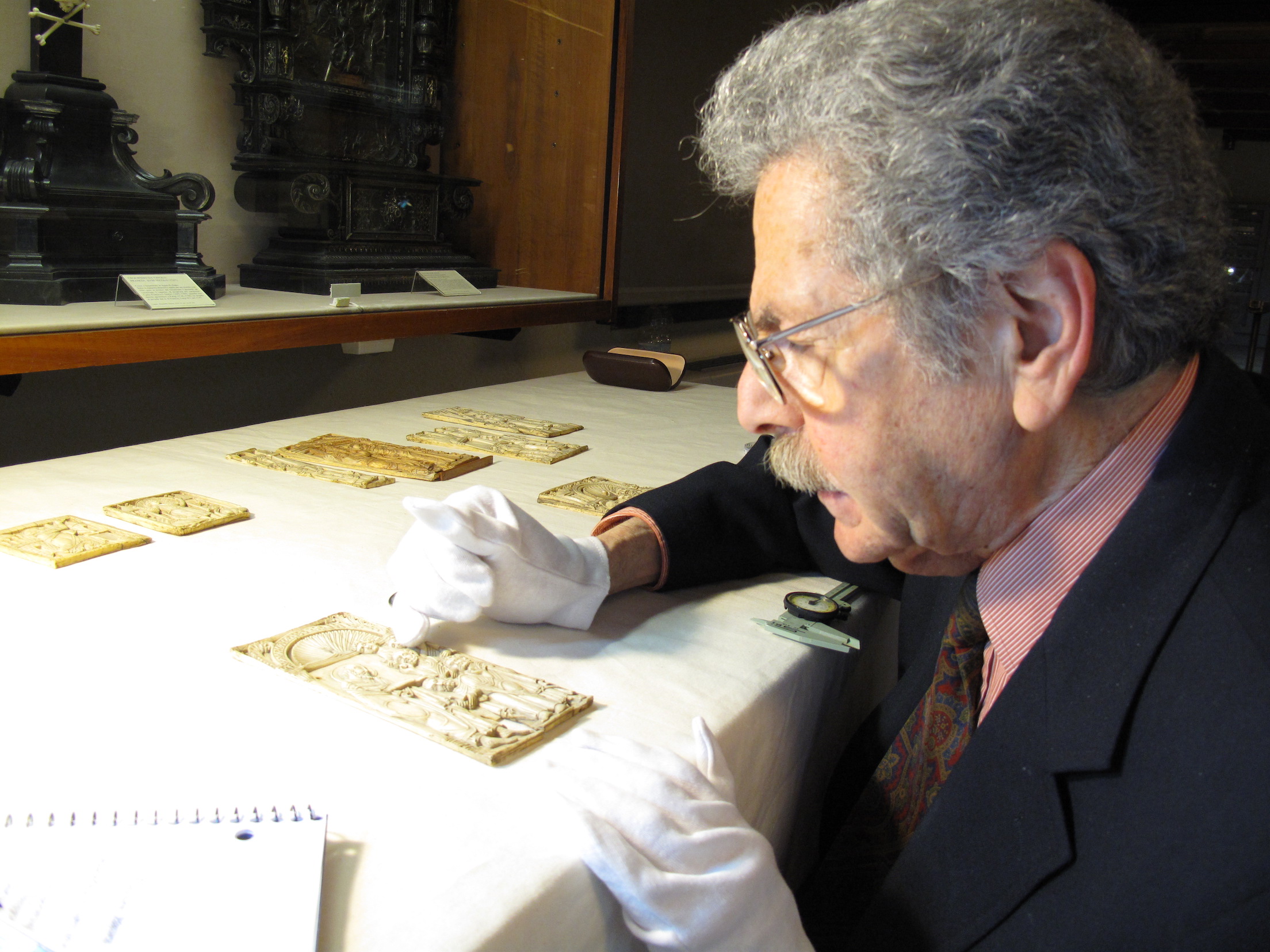 Evan Pugh Professor of Art History, Dr. Anthony Cutler examines an ivory