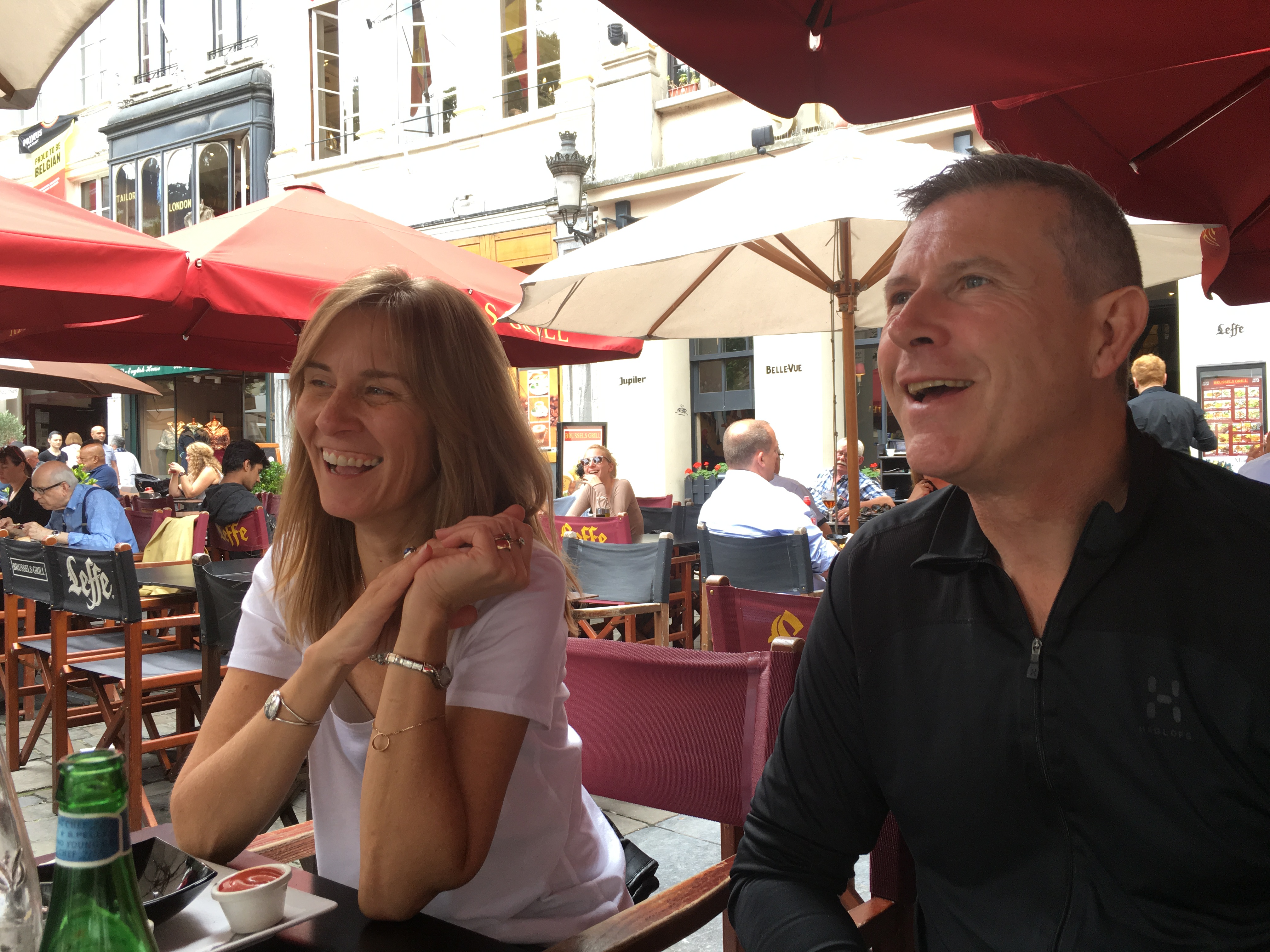 Laurie Mulvey and David Holloway laughing at an outdoor cafe