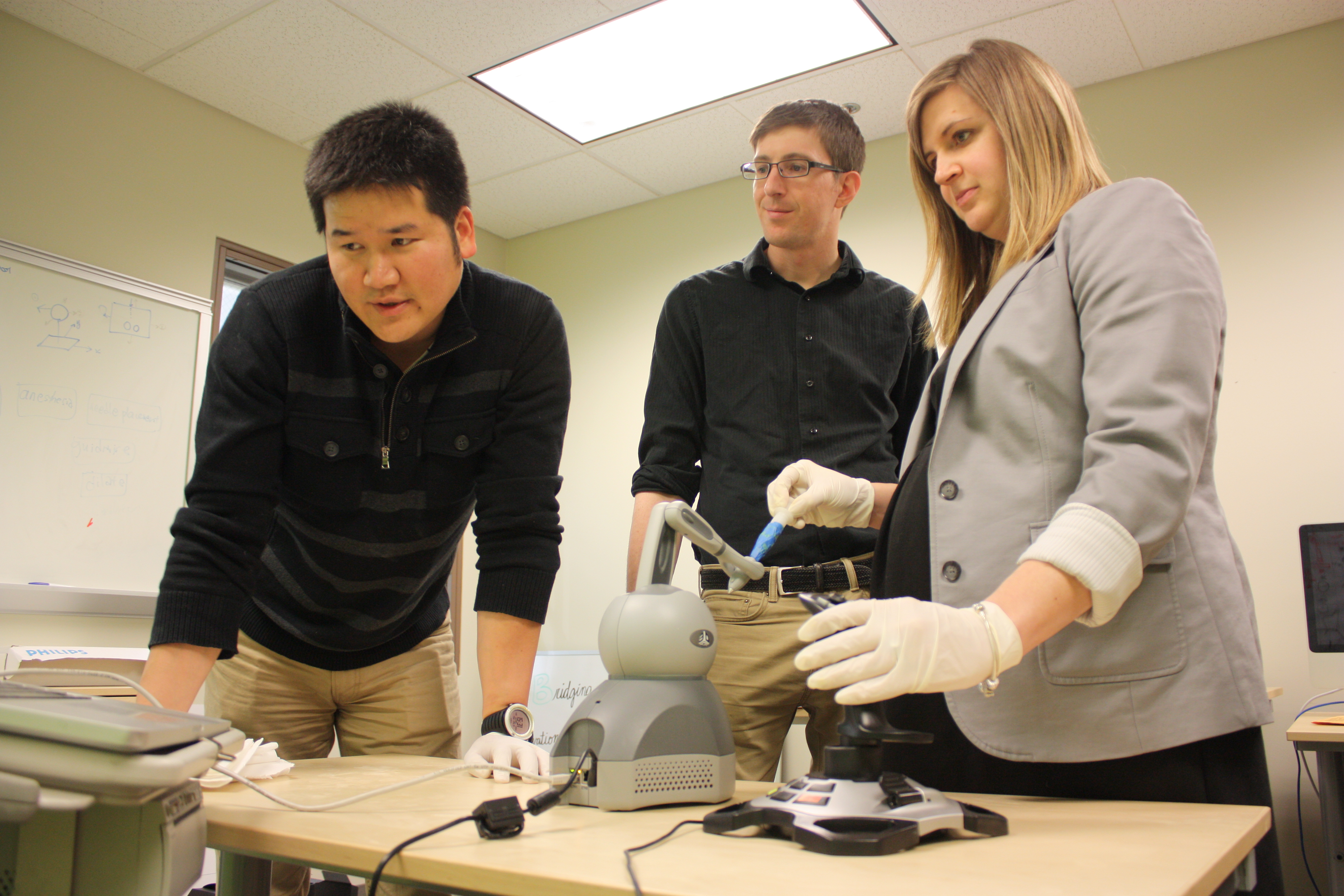 Scarlett Miller, assistant professor demonstrates the haptic robot. 