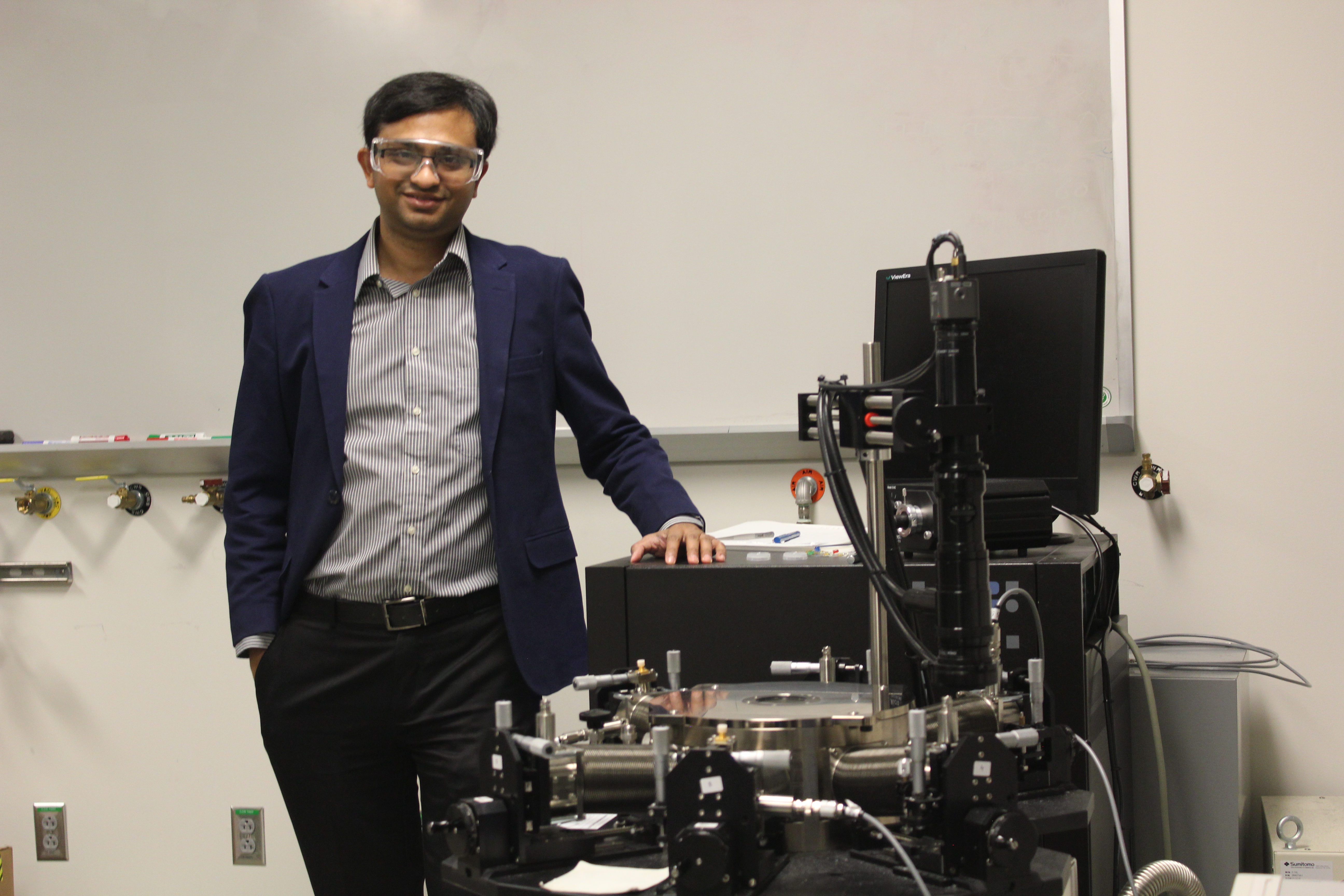 image of man in lab dressed in business casual attire.