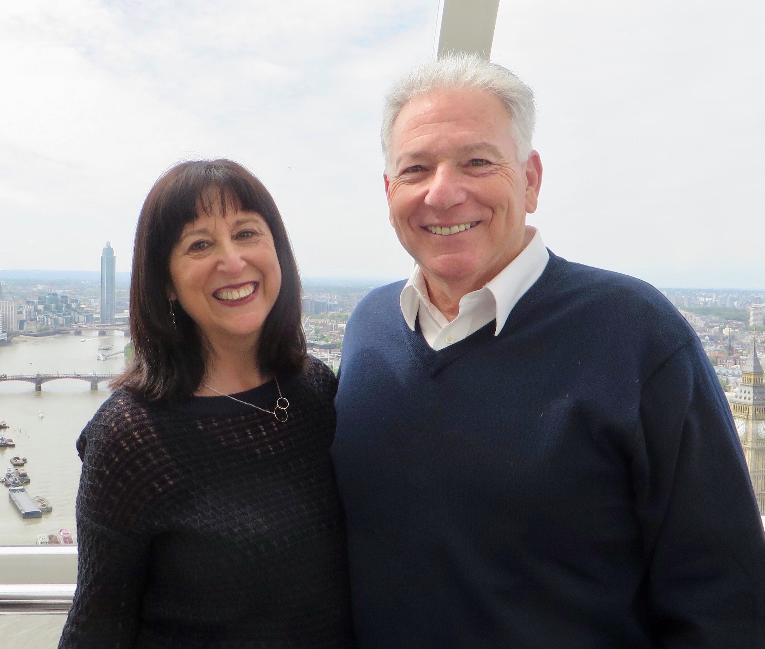 Iris and Ed Beckwith pose in front of an urban overlook