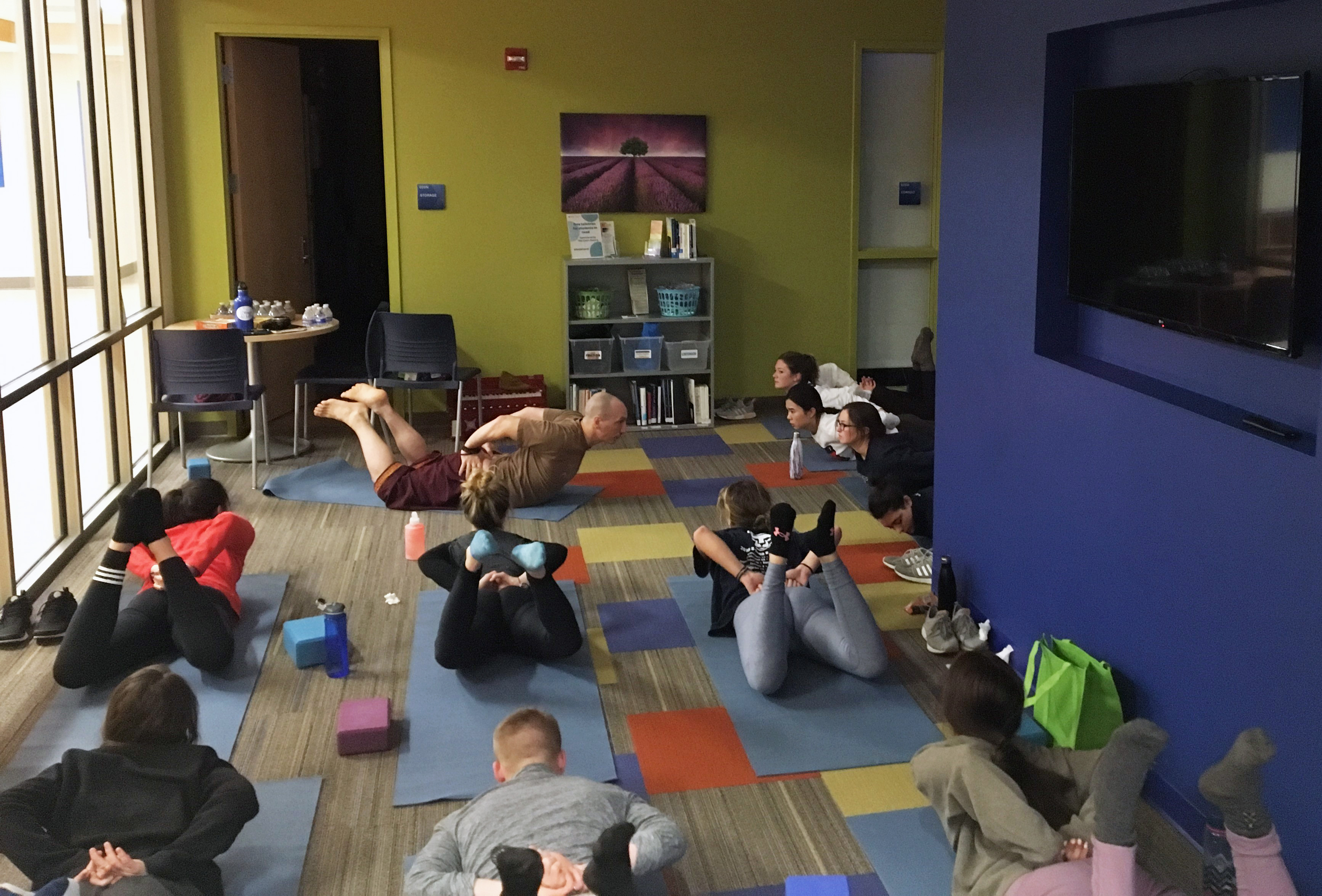 Students take part in yoga exercises as part of a wellness retreat during the spring 2019 semester.