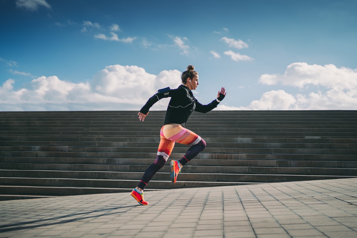 A woman runs outdoors.