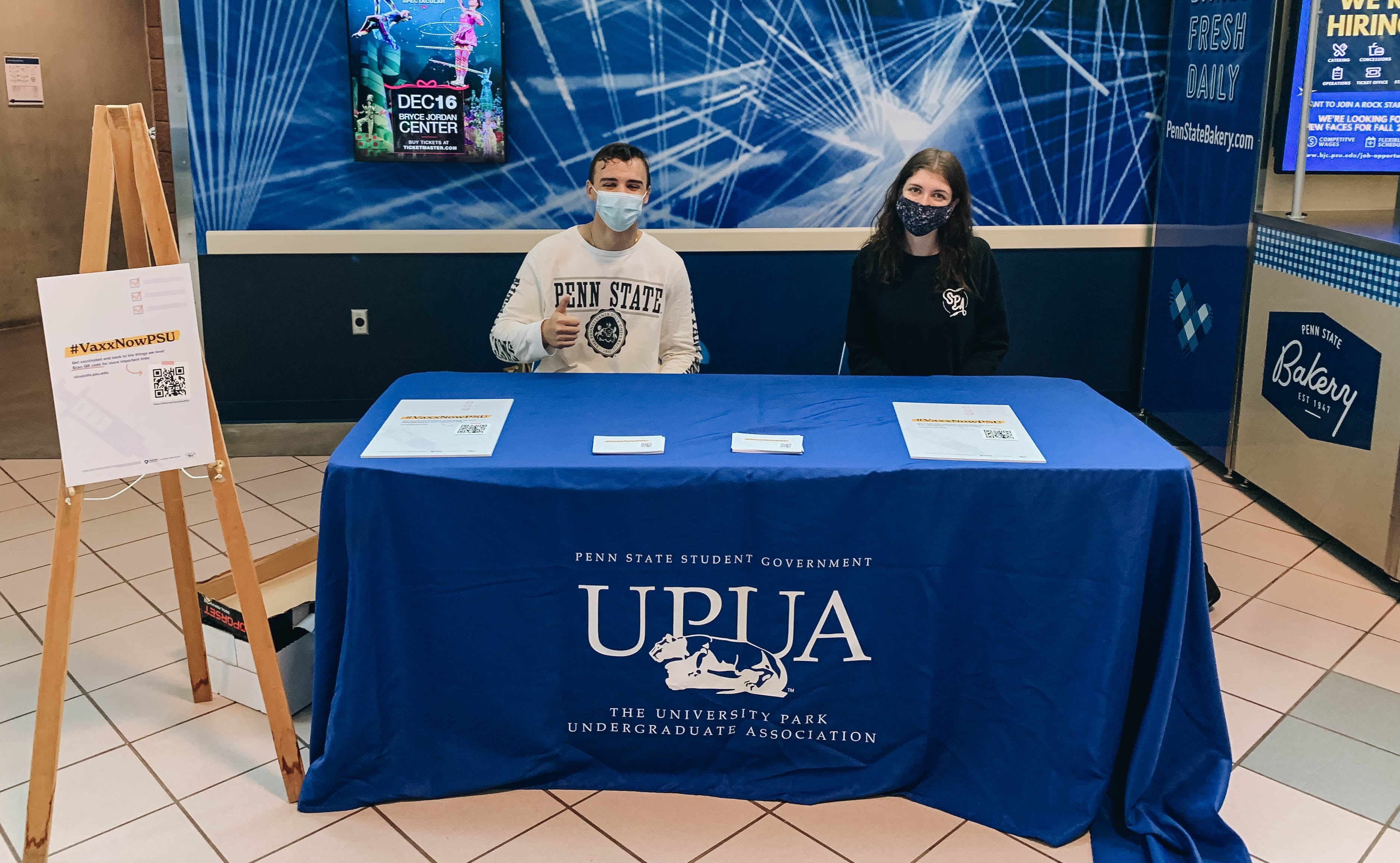 two students sit at a UPUA table