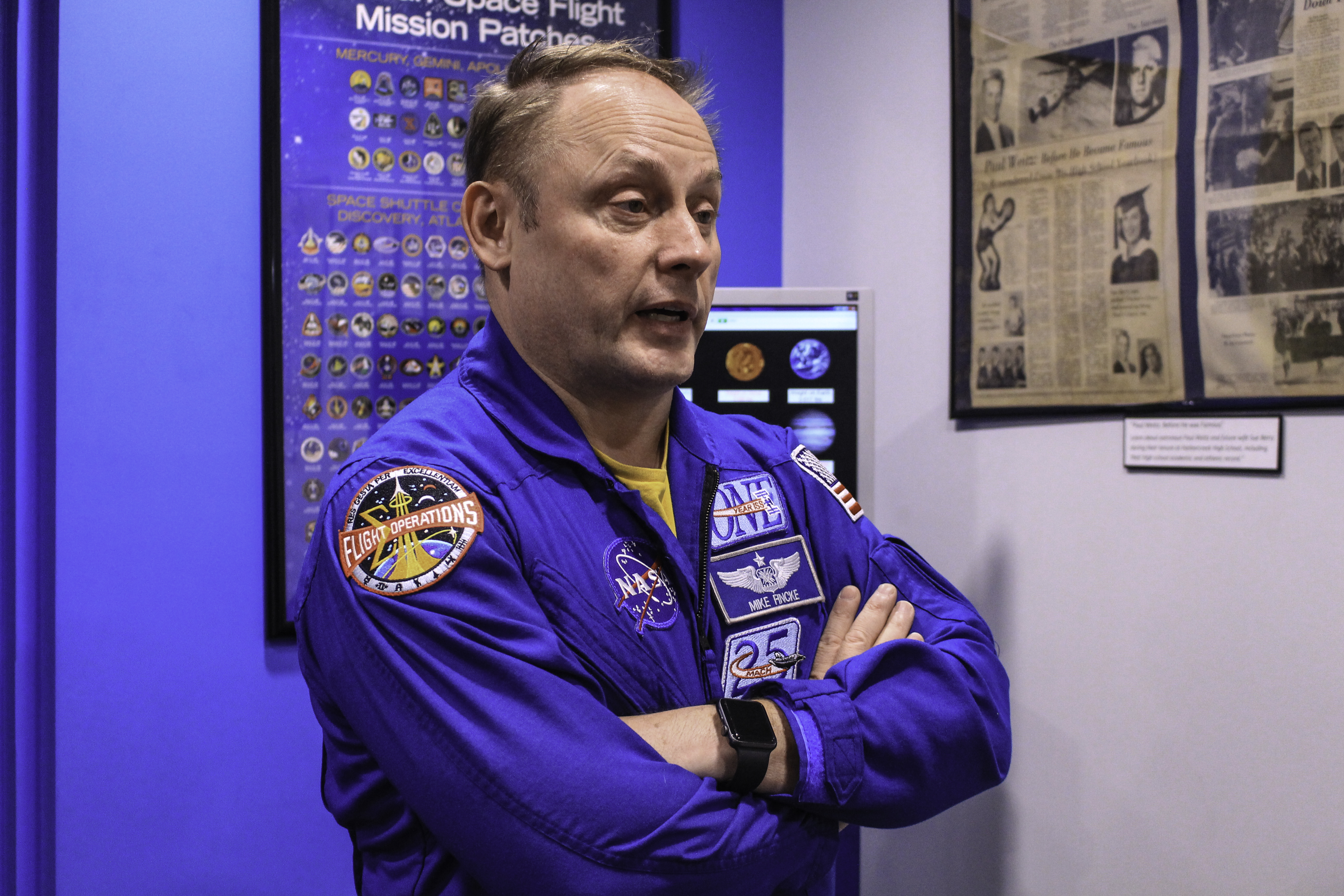 NASA astronaut Mike Fincke talks to a reporter at Penn State Behrend.