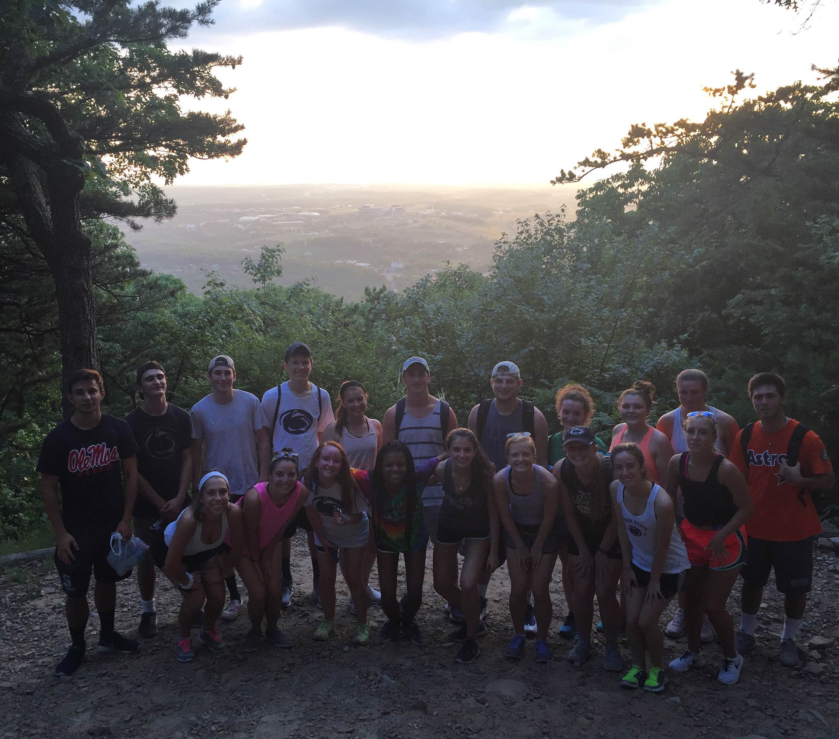 A group of LEAP students stand atop Mount Nittany posing for the camera