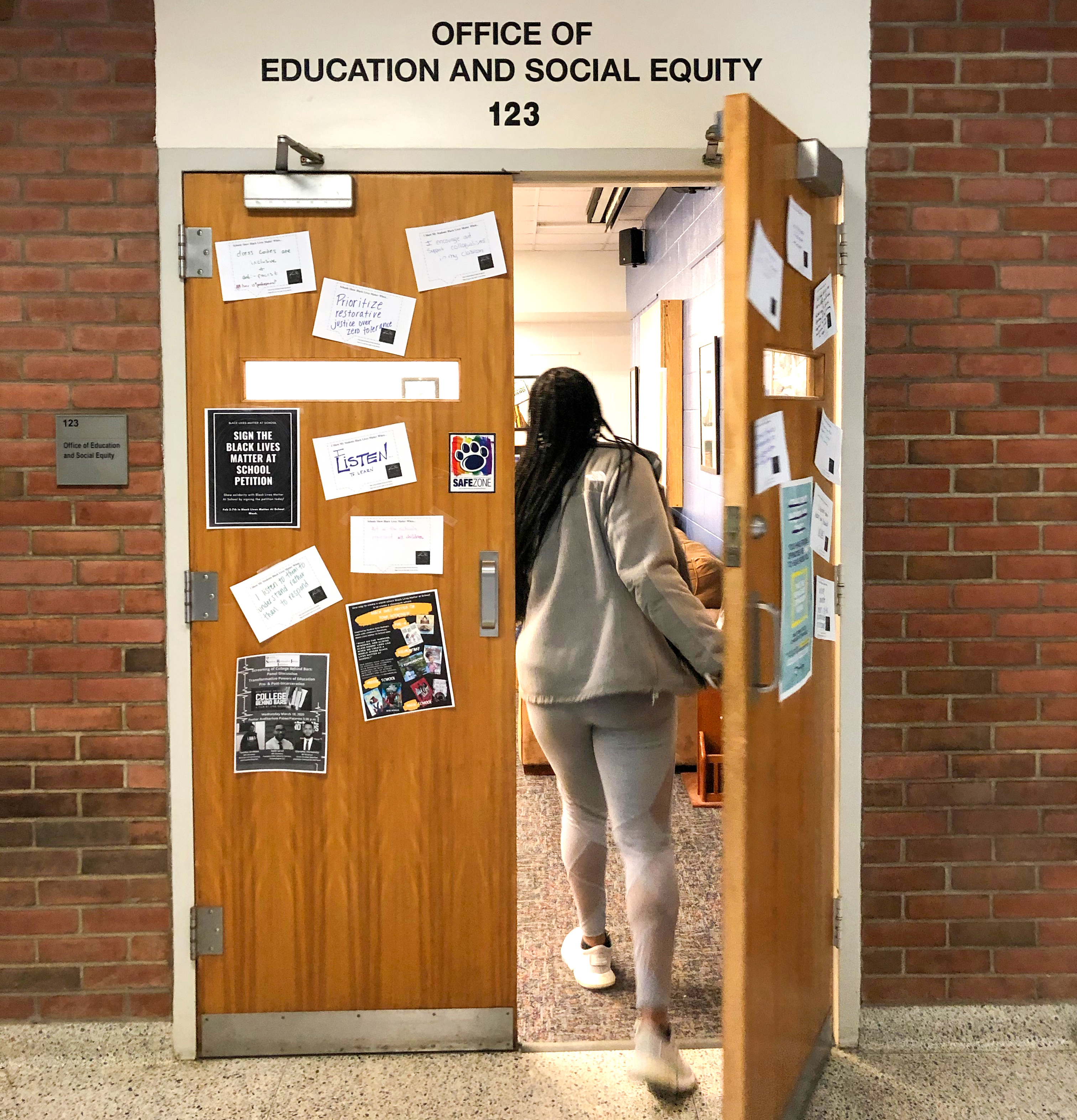 Student walking into the Office of Education and Social Equity