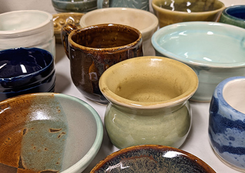 A grouping of ceramic pots and mugs