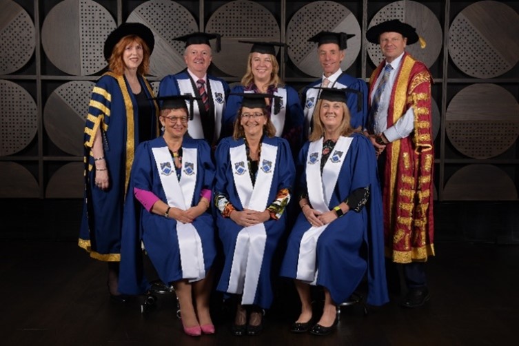 A group of professors posing for a photo