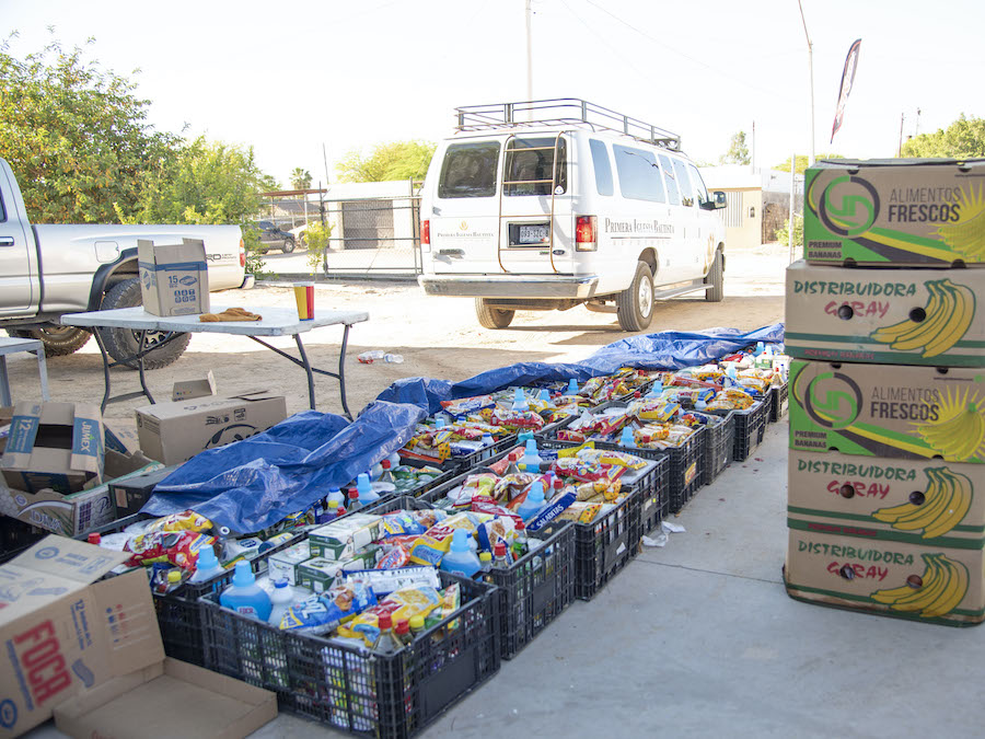 Photo of crates filled with food and cleaning supplies