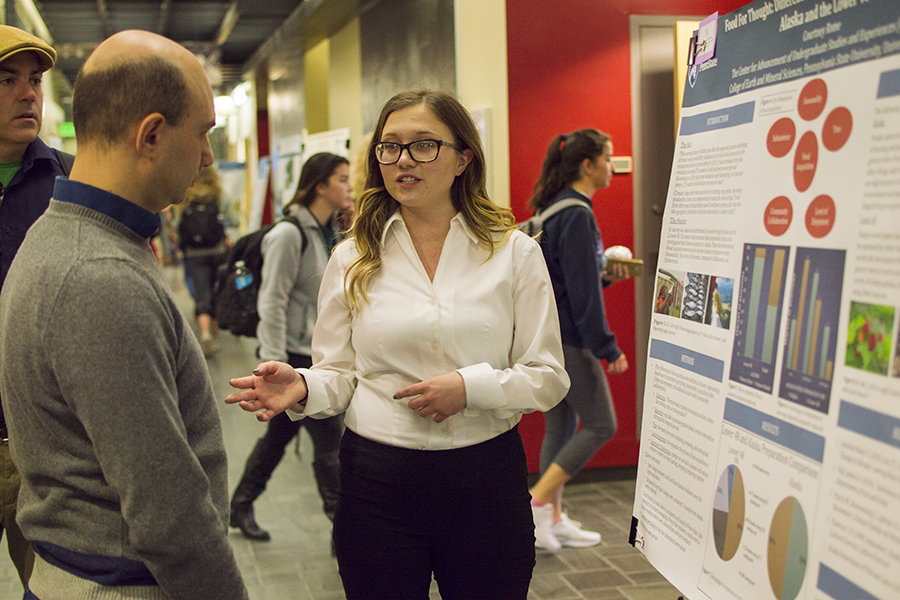 Courtney Rome, a senior majoring in geography, discusses her first-place-winning poster with Guido Cervone, associate professor in the Department of Geography and Institute for CyberScience.