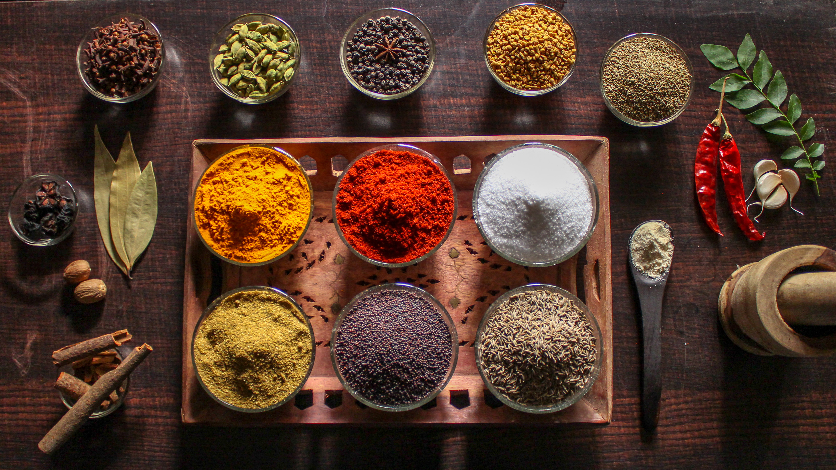 An array of brightly colored spices laid out on a table