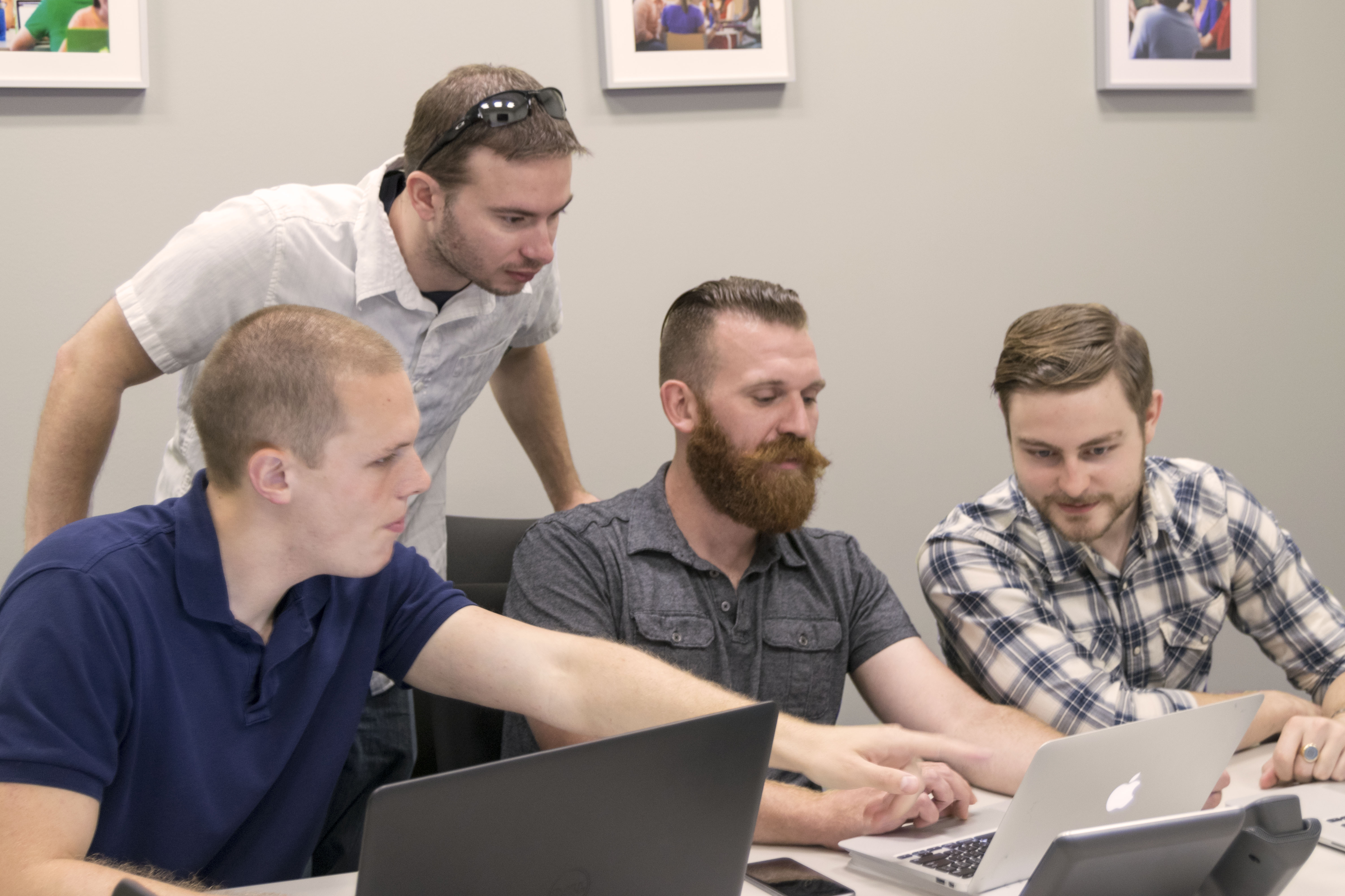 Four members of the Competitive Cyber Security Organization gather around a computer