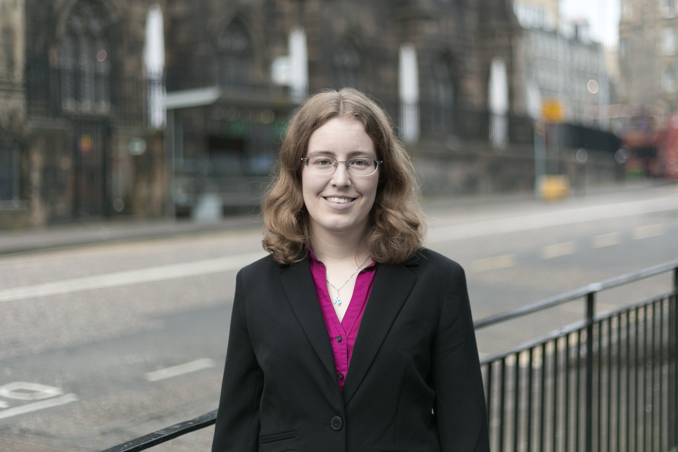 photo of professional female standing on the street