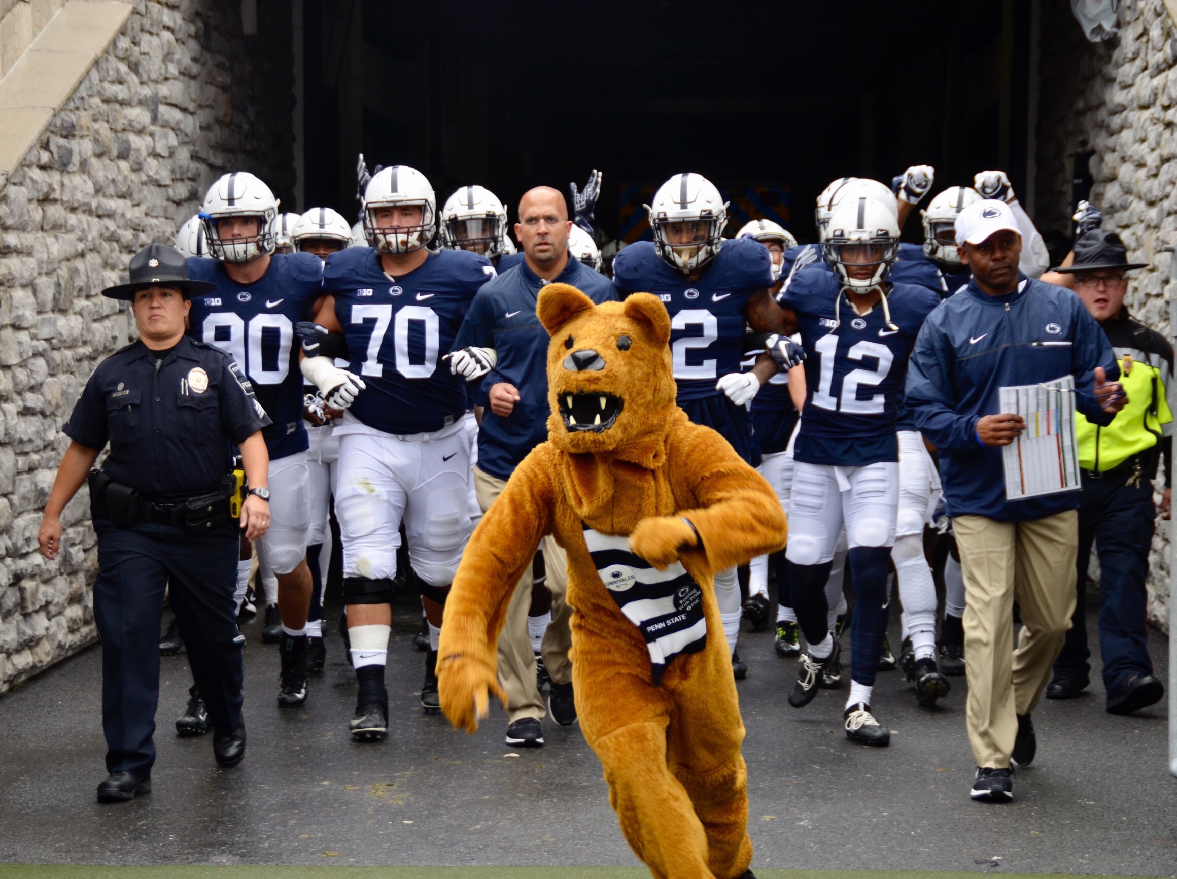 The Nittany Lion mascot leads the football team onto the field 
