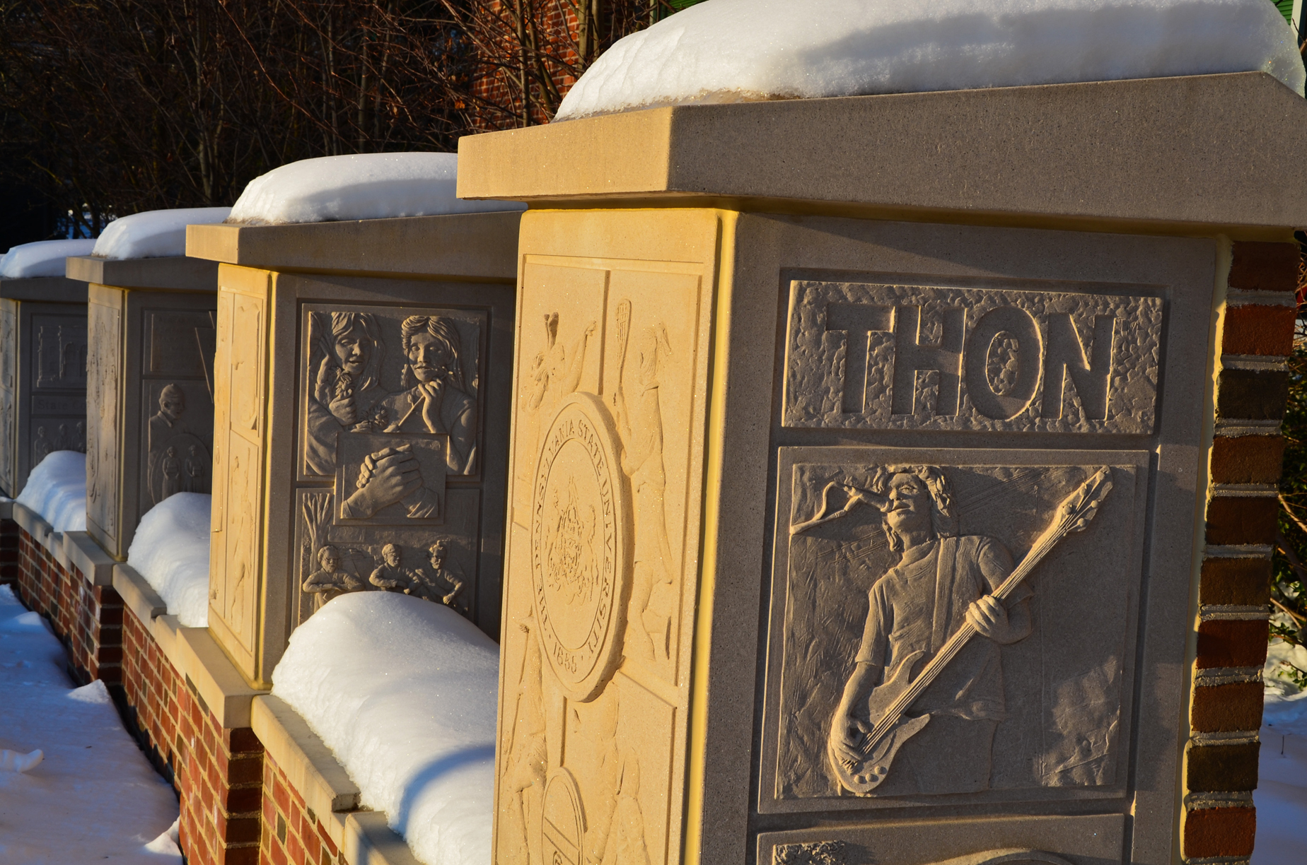 A low snow-covered wall with four pillars depicts student life at Penn State was the Senior Class Gift of 2005.