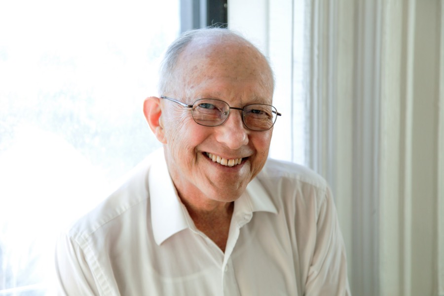 A bespectacled man smiles for the camera.