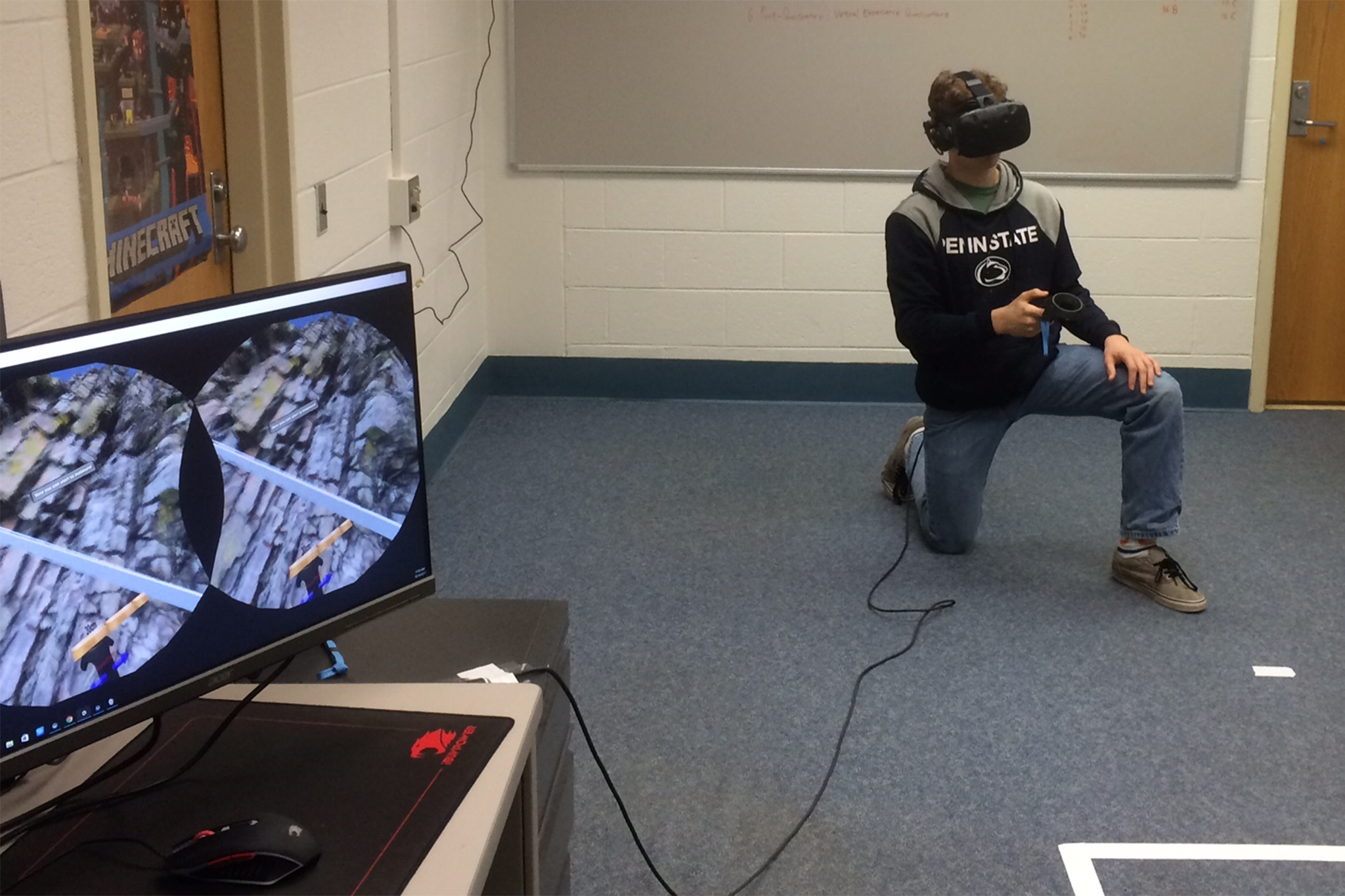 A student uses HTC Vive to measure the thickness of rock layers. The virtual content is synchronized to a desktop screen. 