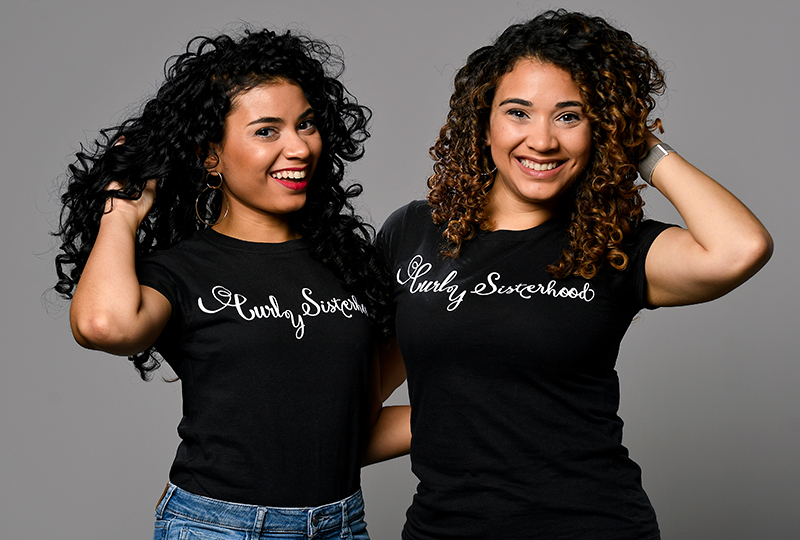 The Varona Sisters pose with their Curly Sisterhood t-shirts.