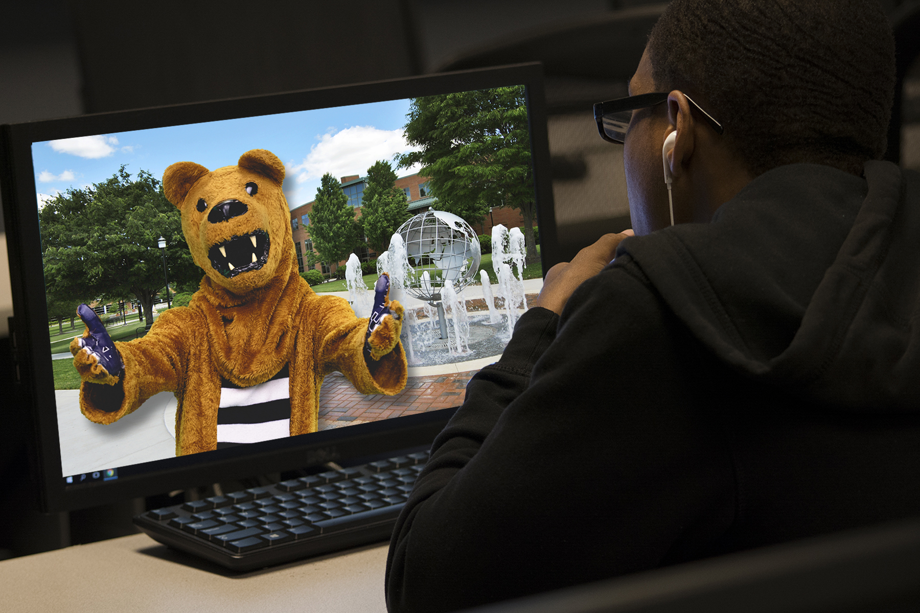 student looking at Nittany Lion on computer screen